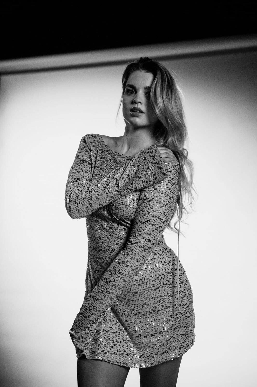 Hannah K in Black and White portraits story frame 32: A black-and-white studio portrait study with clean wardrobe shifts, close face work and controlled light.