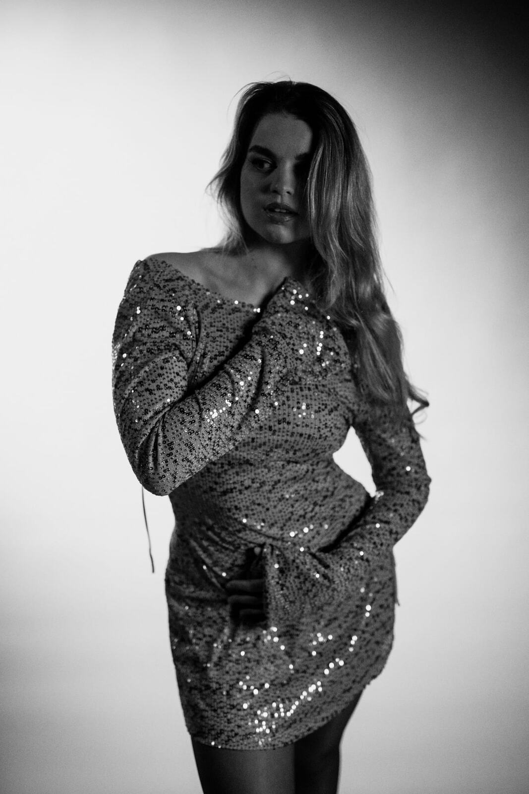 Hannah K in Black and White portraits story frame 9: A black-and-white studio portrait study with clean wardrobe shifts, close face work and controlled light.