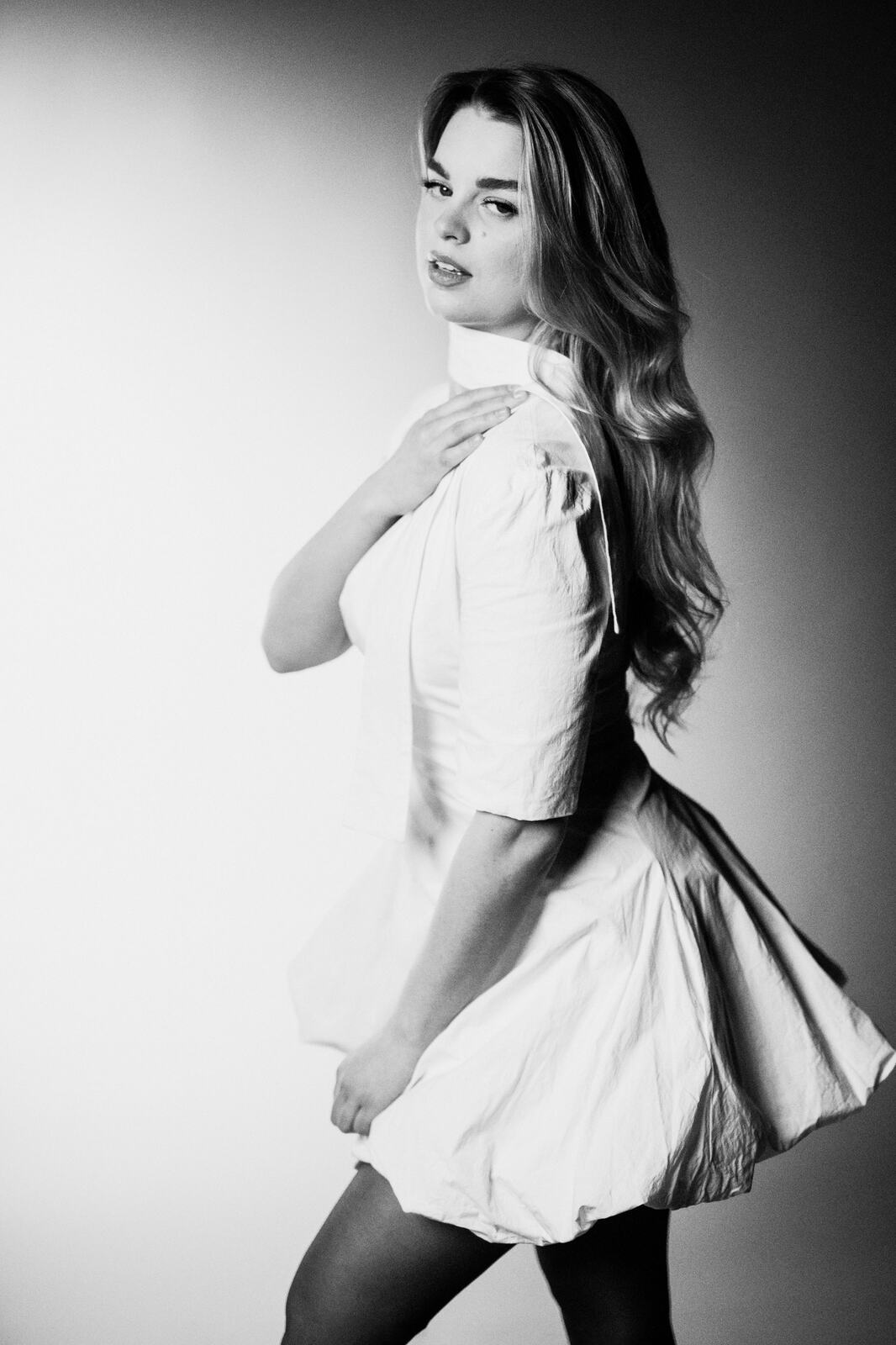 Hannah K in Black and White portraits story frame 18: A black-and-white studio portrait study with clean wardrobe shifts, close face work and controlled light.