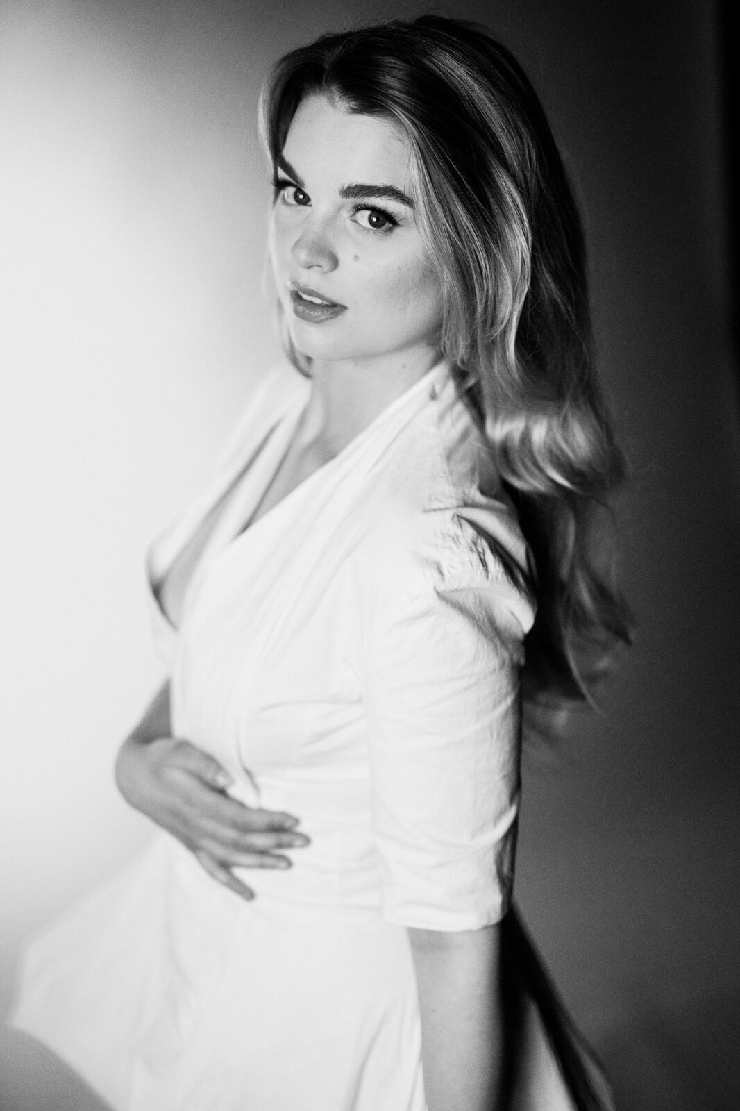 Hannah K in Black and White portraits story frame 20: A black-and-white studio portrait study with clean wardrobe shifts, close face work and controlled light.