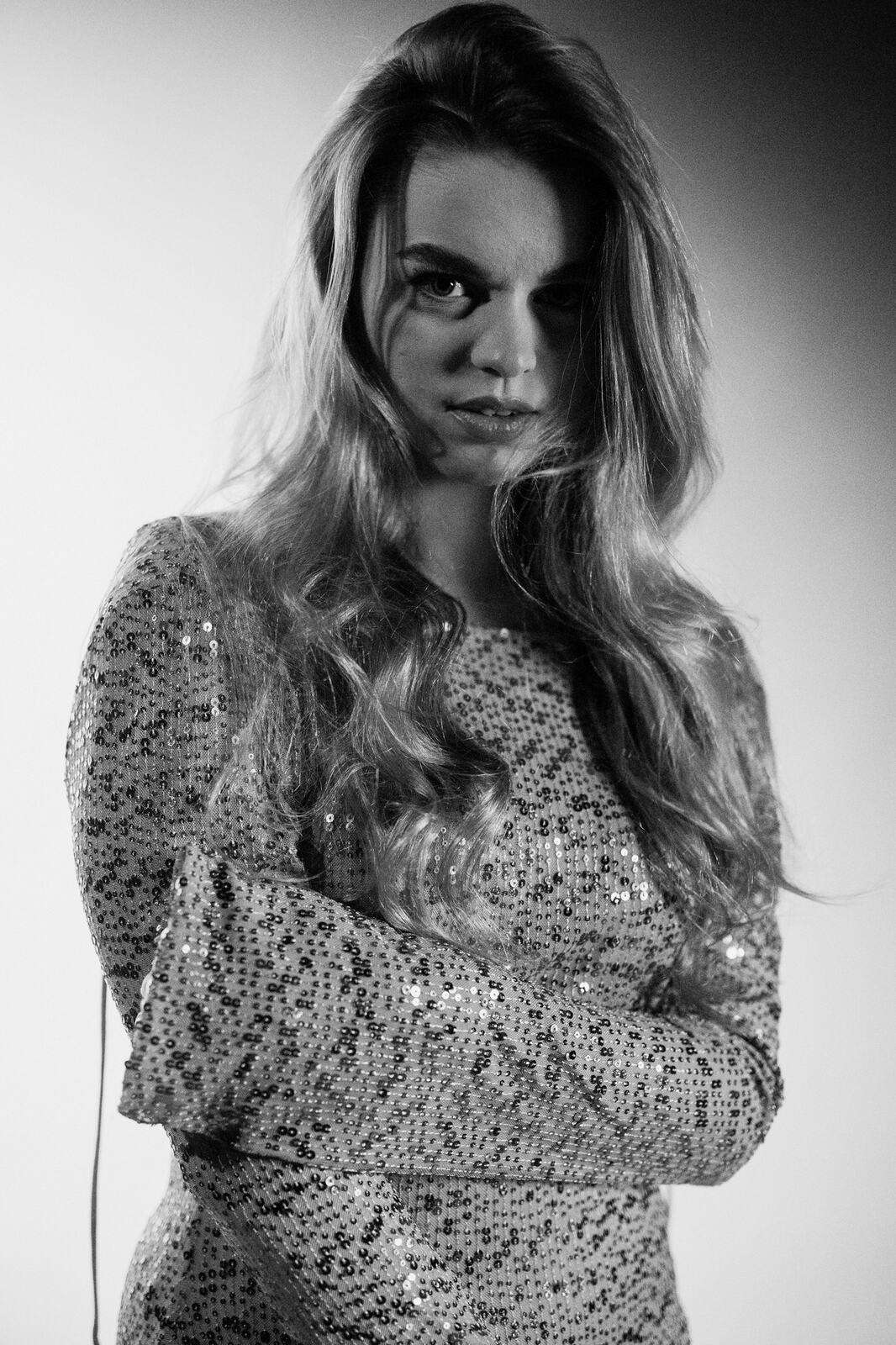 Hannah K in Black and White portraits story frame 40: A black-and-white studio portrait study with clean wardrobe shifts, close face work and controlled light.