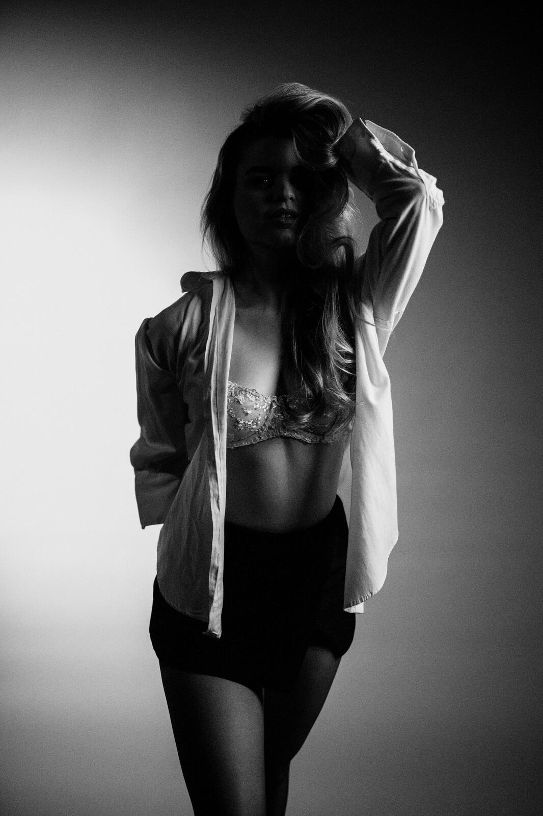 Hannah K in Black and White portraits story frame 27: A black-and-white studio portrait study with clean wardrobe shifts, close face work and controlled light.