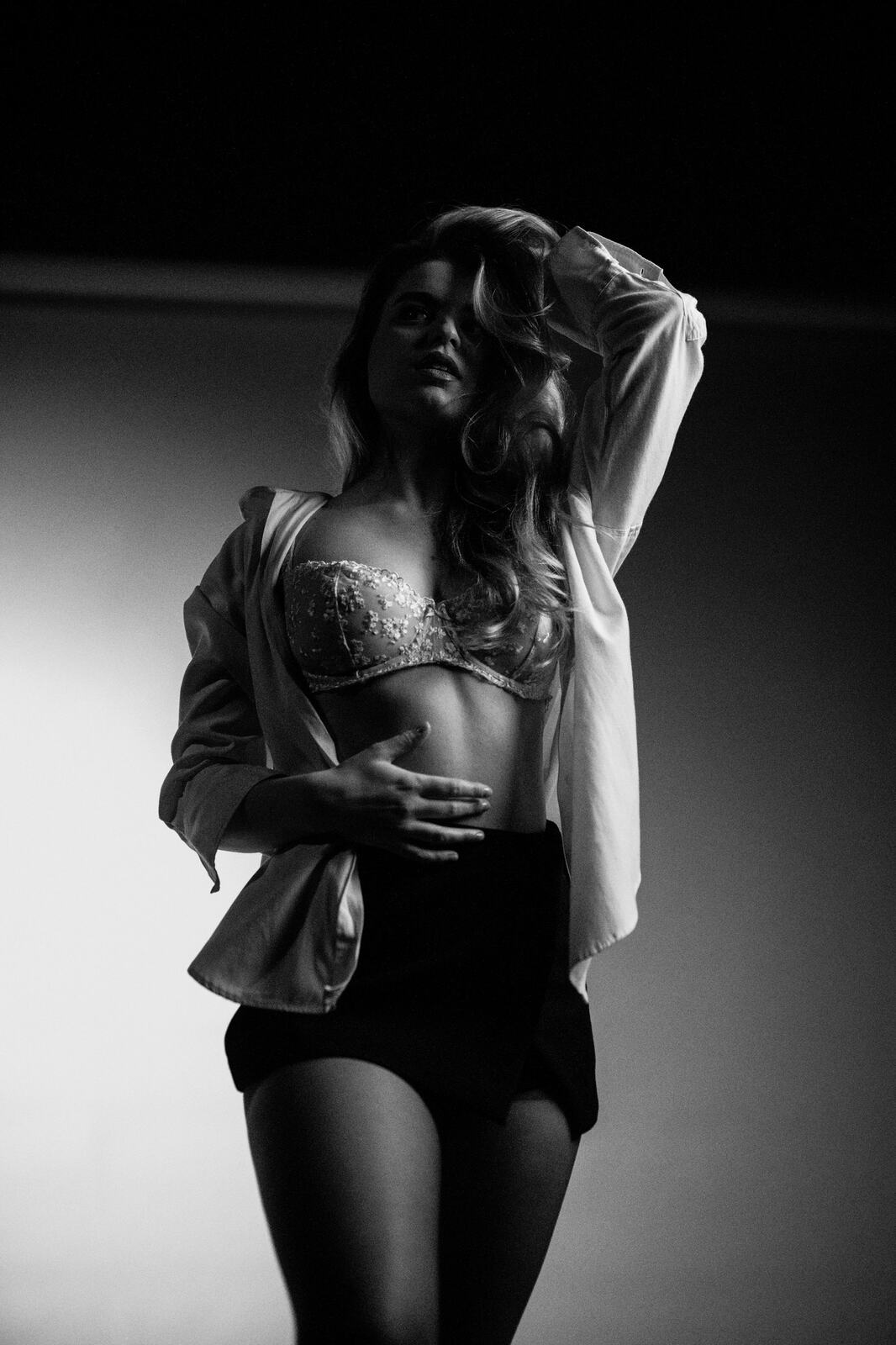 Hannah K in Black and White portraits story frame 29: A black-and-white studio portrait study with clean wardrobe shifts, close face work and controlled light.