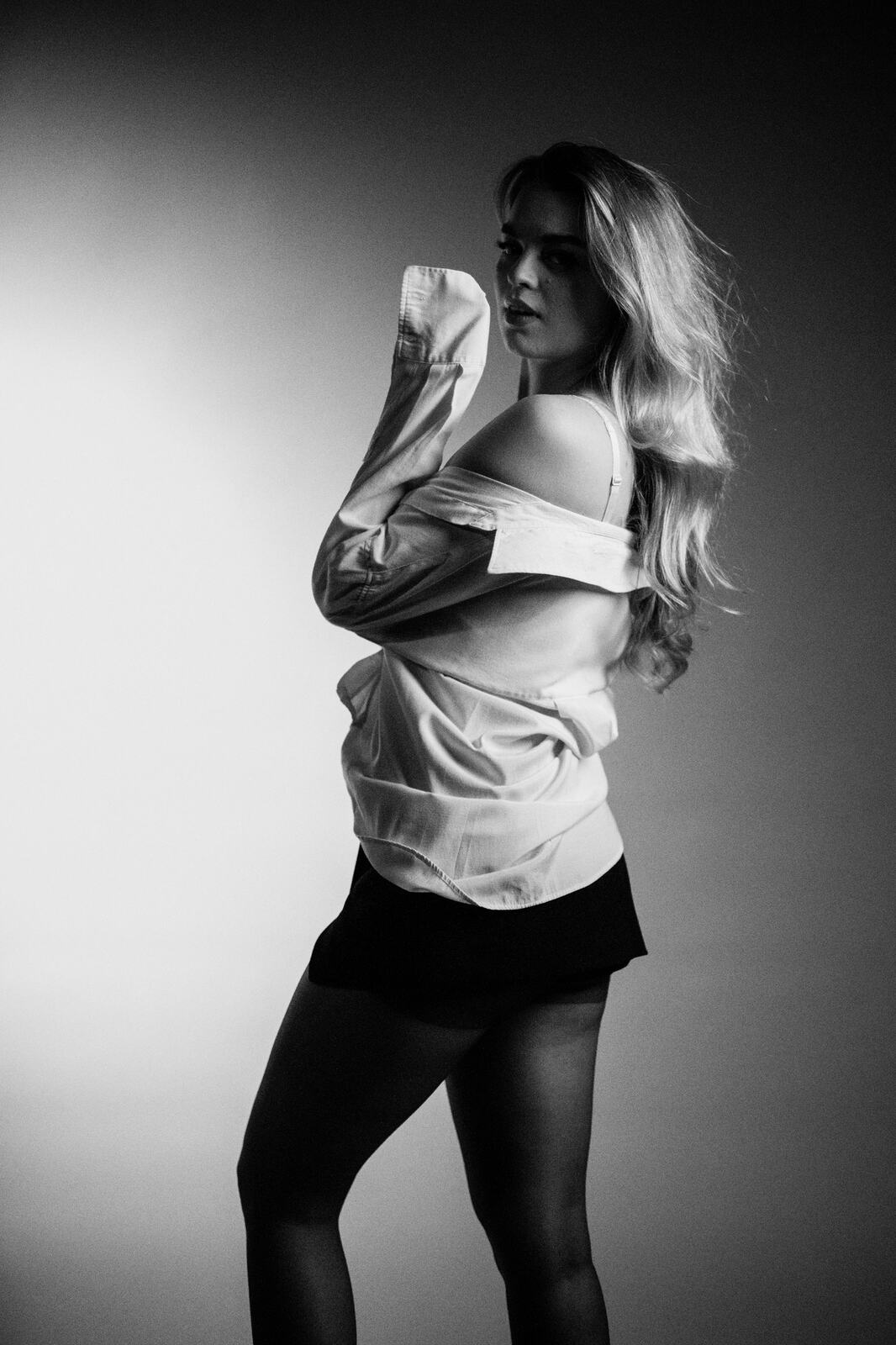 Hannah K in Black and White portraits story frame 30: A black-and-white studio portrait study with clean wardrobe shifts, close face work and controlled light.