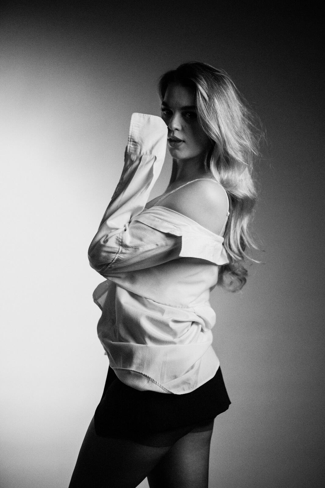 Hannah K in Black and White portraits story frame 31: A black-and-white studio portrait study with clean wardrobe shifts, close face work and controlled light.