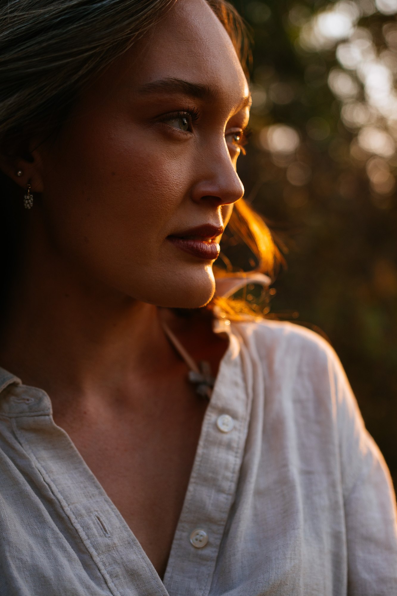 Holly — quiet profile in warm light among the trees
