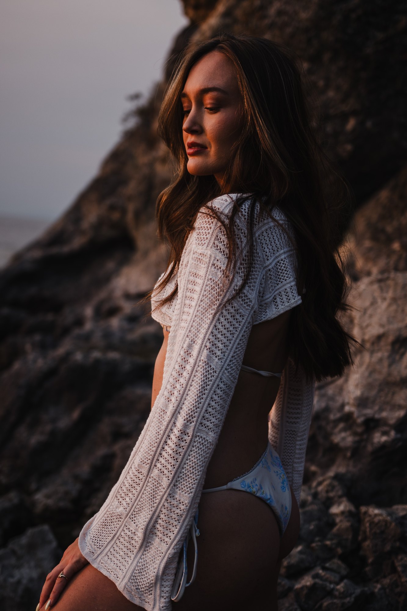 Holly — seated side portrait beside the shoreline