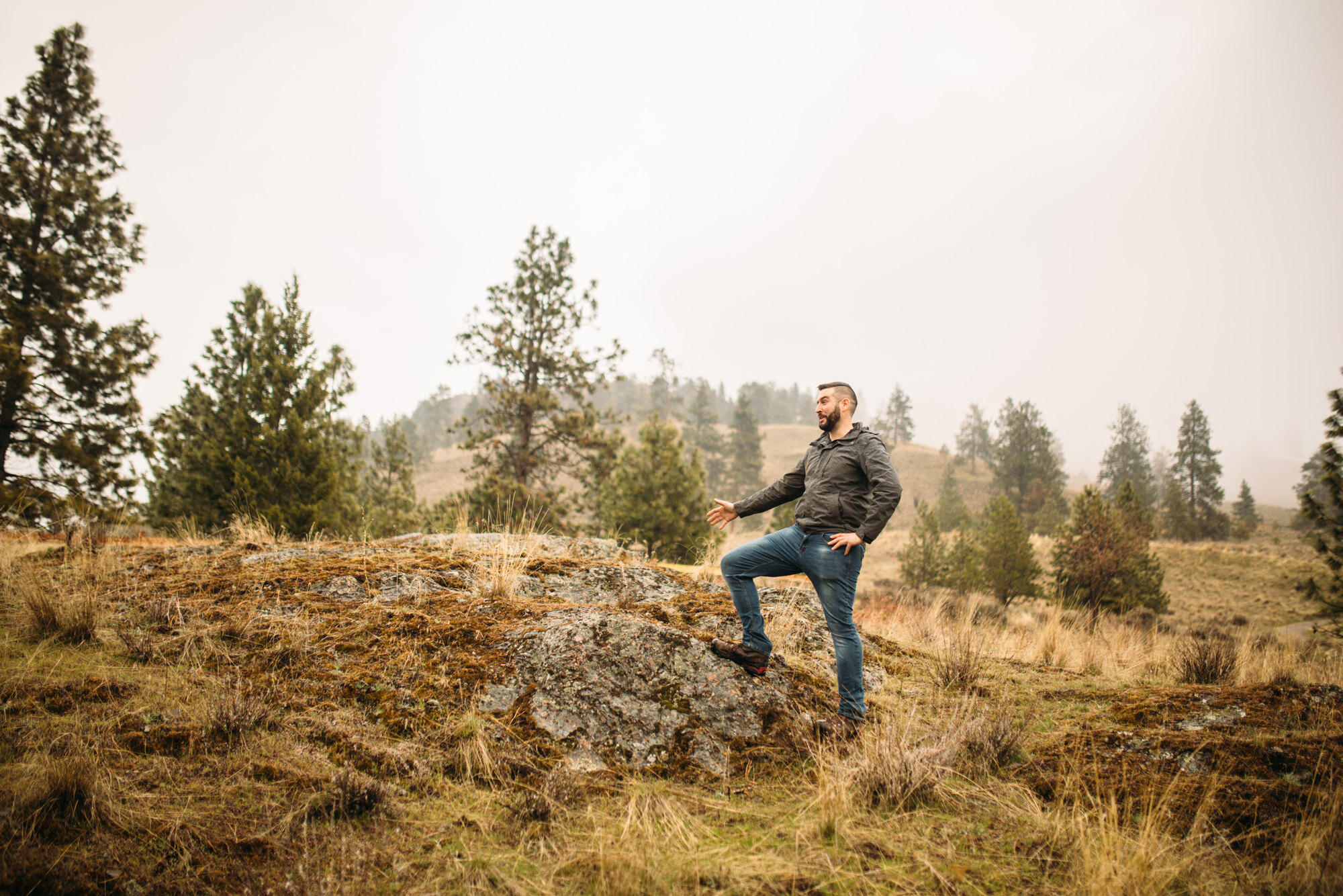 Seated environmental portrait of Jeremy on dry Knox Mountain grass.