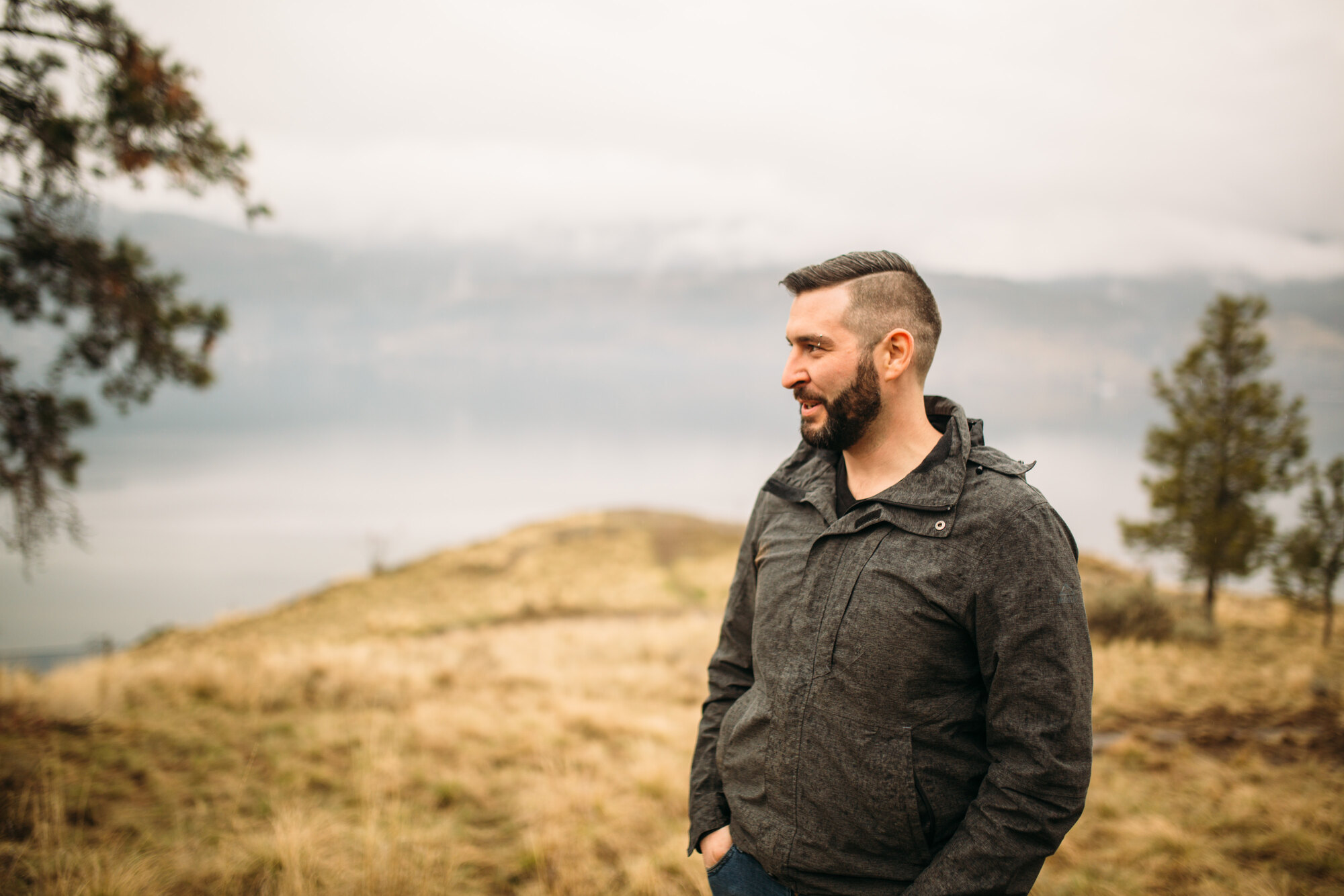 Side-profile portrait of Jeremy looking across the Okanagan hillside.