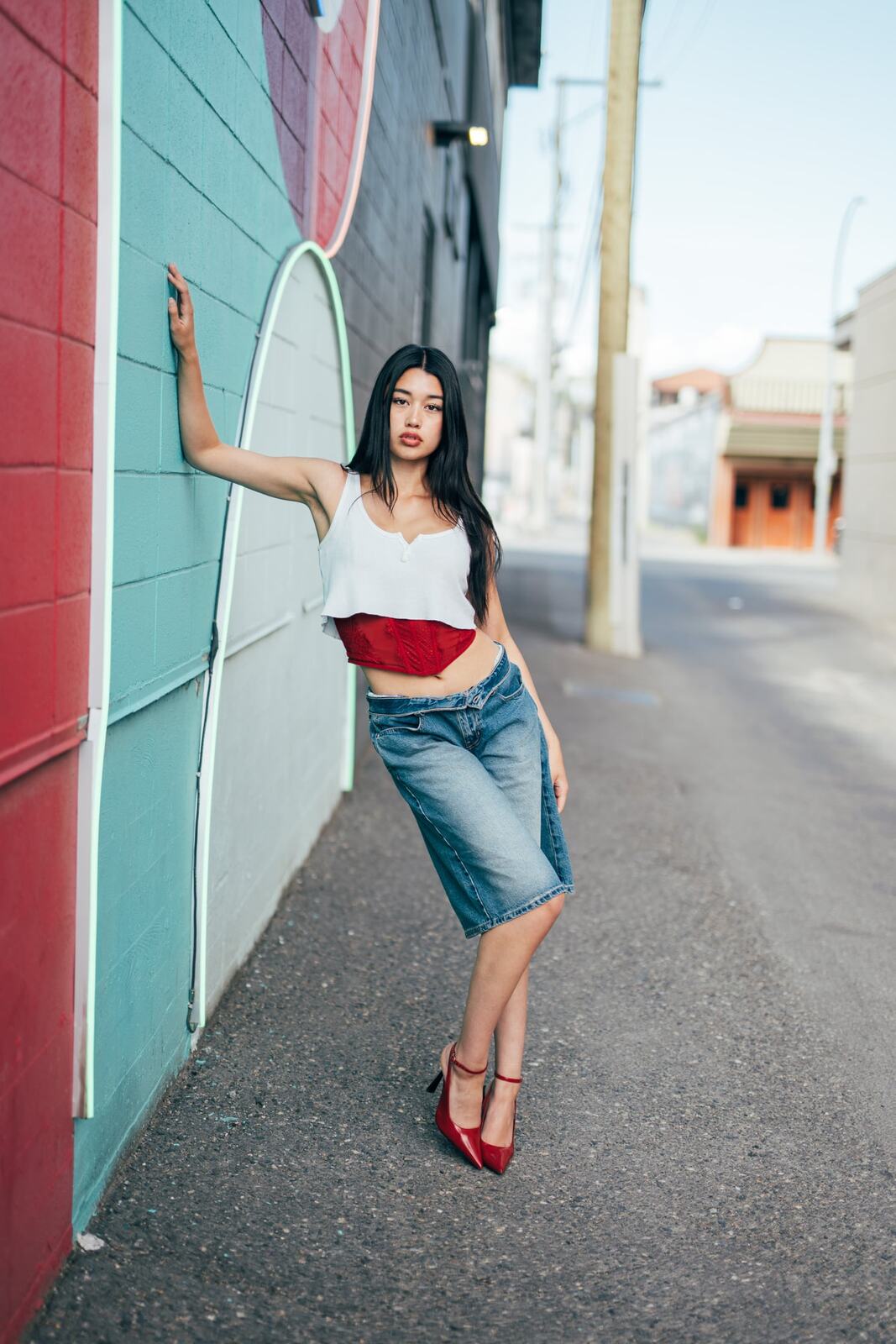 Julia in Kamloops portraits story frame 12: Colour walls, graffiti, black brick, red brick and a city walk with enough range to feel like a little editorial day.