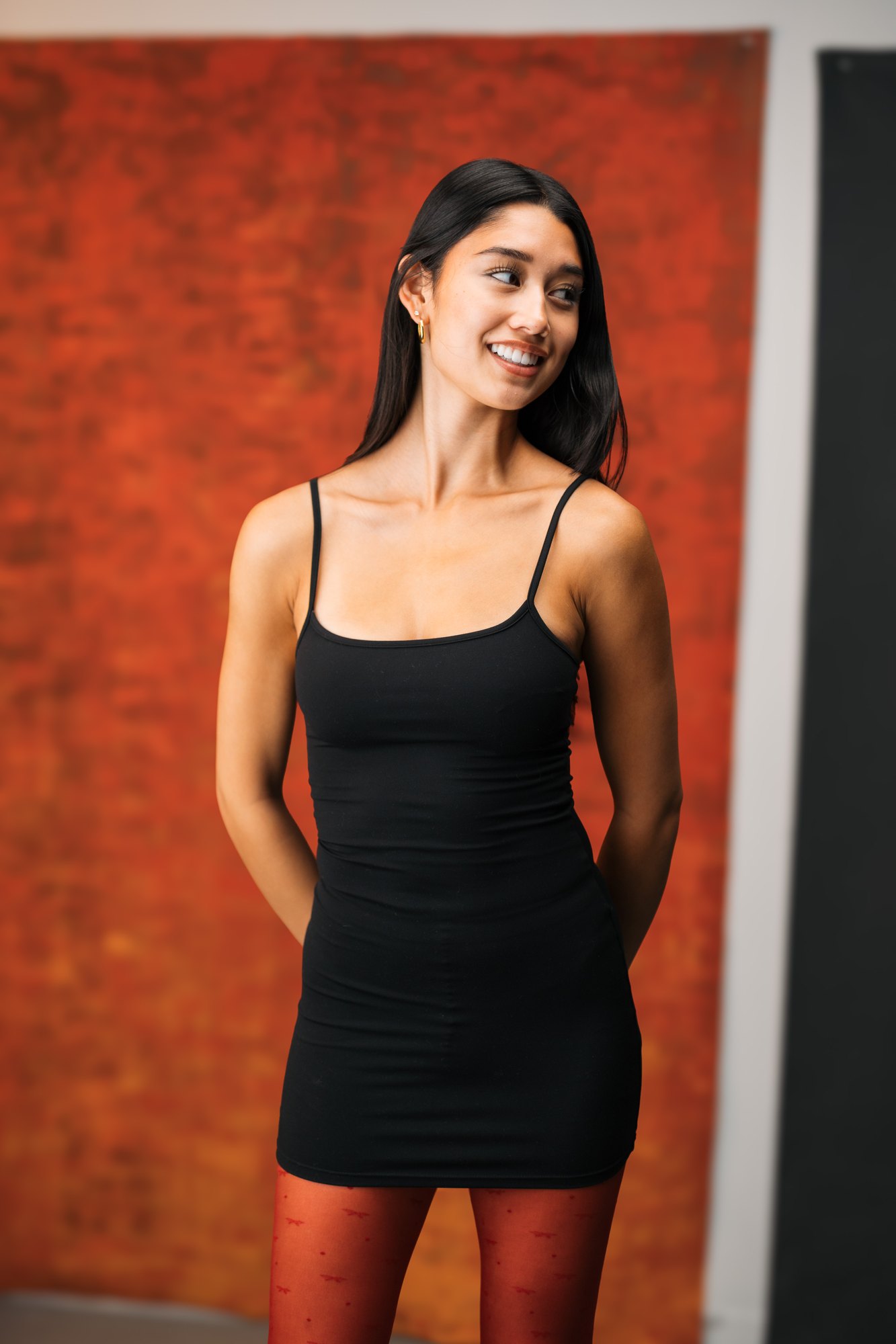 Julia Crofoot — an open smile against the red panel