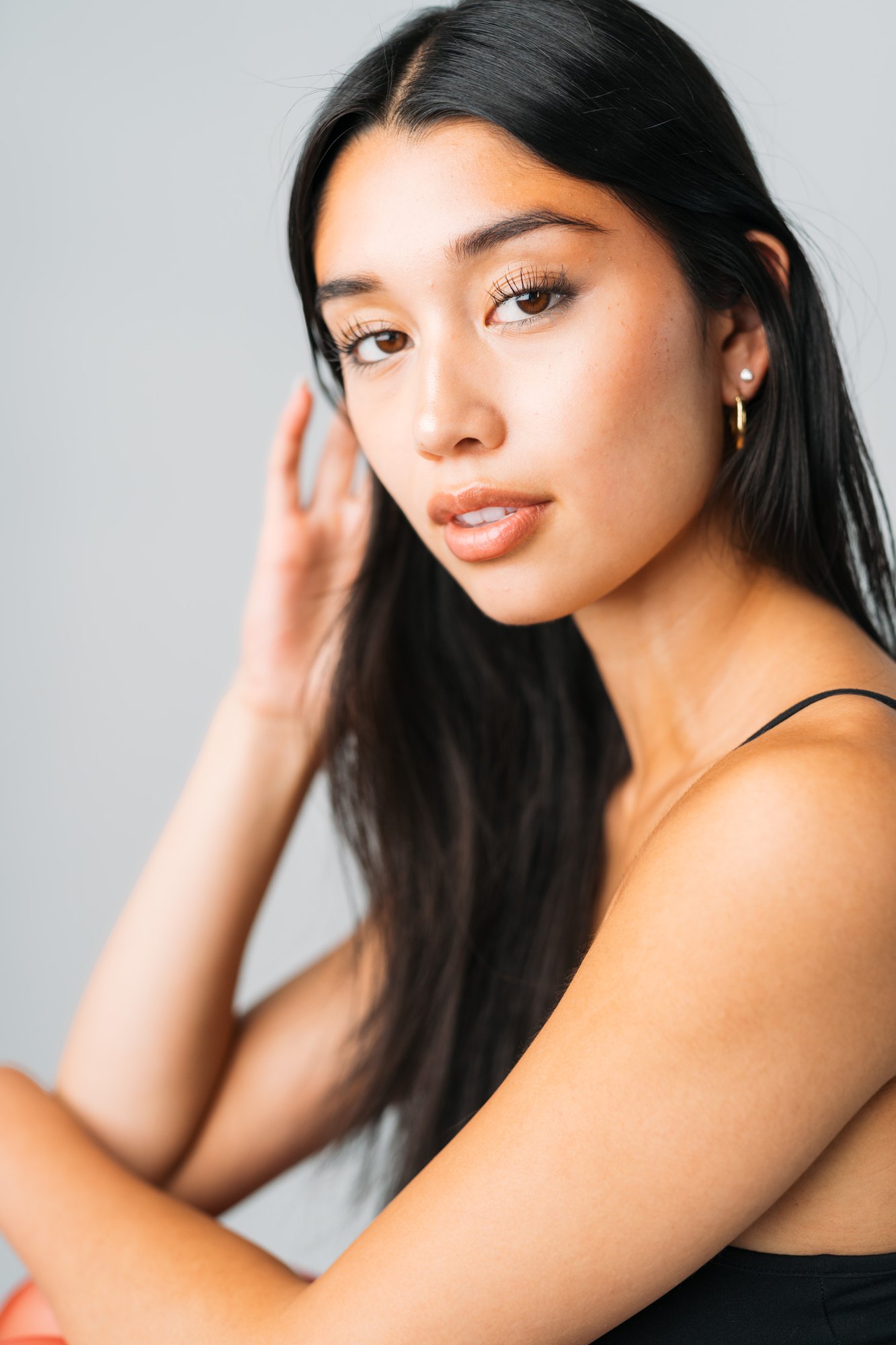Julia Crofoot — quiet close portrait with a hand in her hair