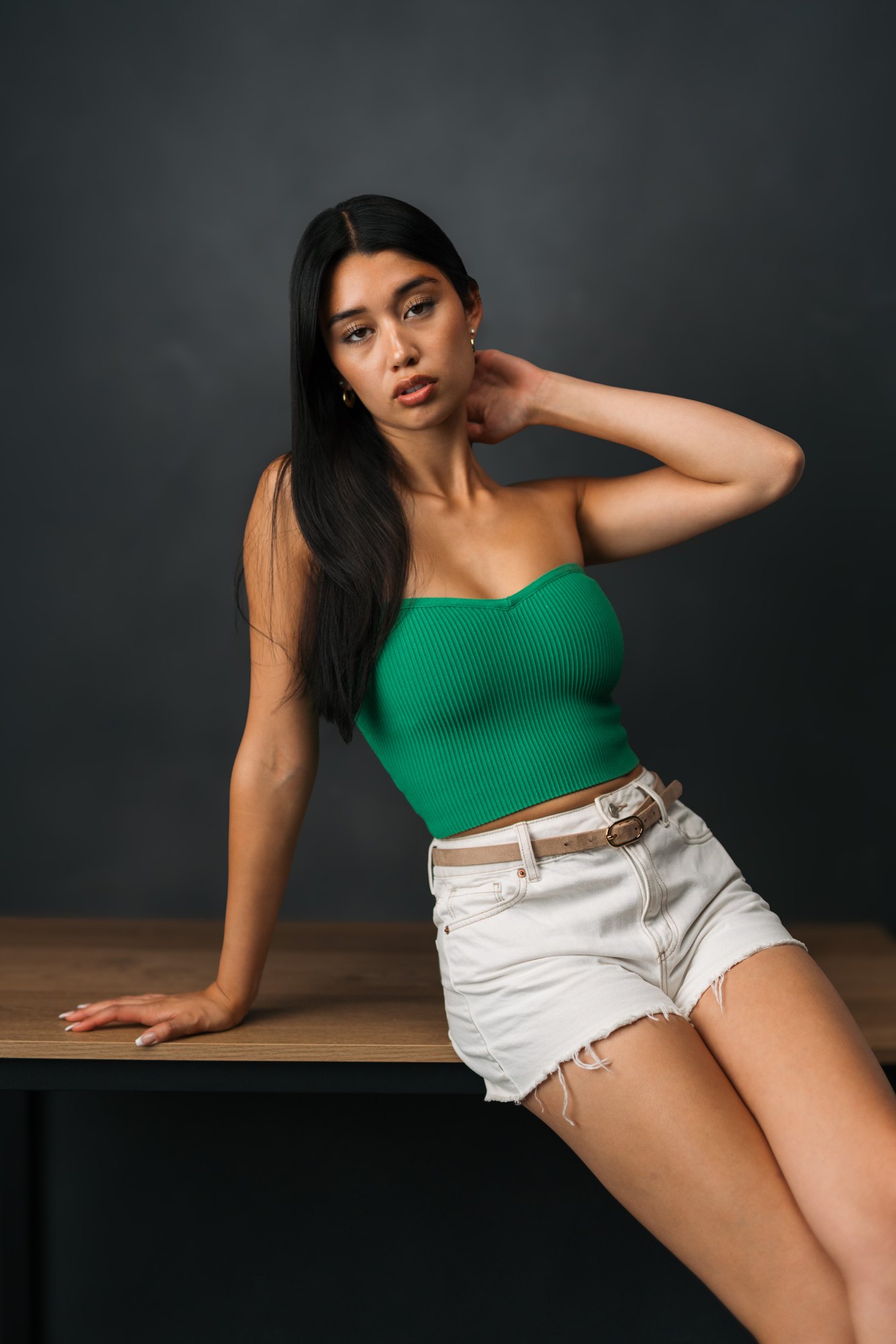 Julia Crofoot — sitting on a table with an arm behind her head