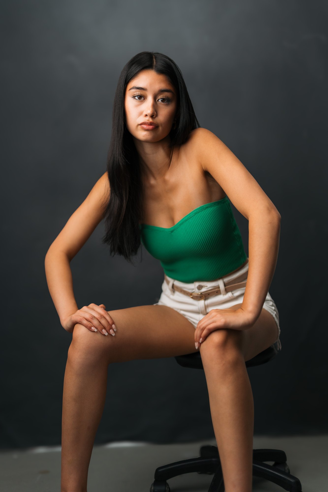 Julia Crofoot — full-length seated portrait on the rolling stool