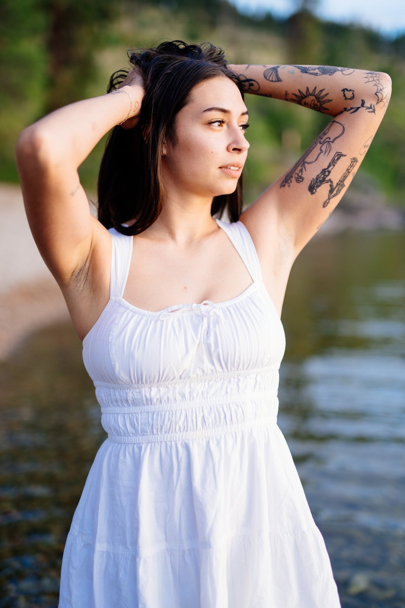 Karly — looking across the lake with both hands in her hair