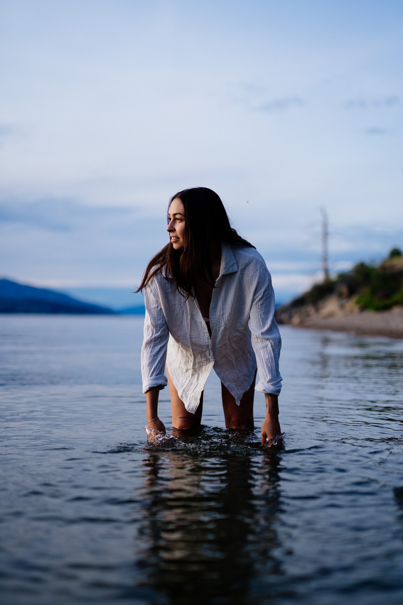 Karly — leaning forward in a white shirt in the water