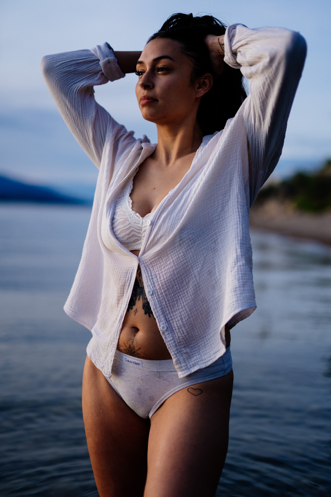 Karly — white shirt portrait with both hands in her hair