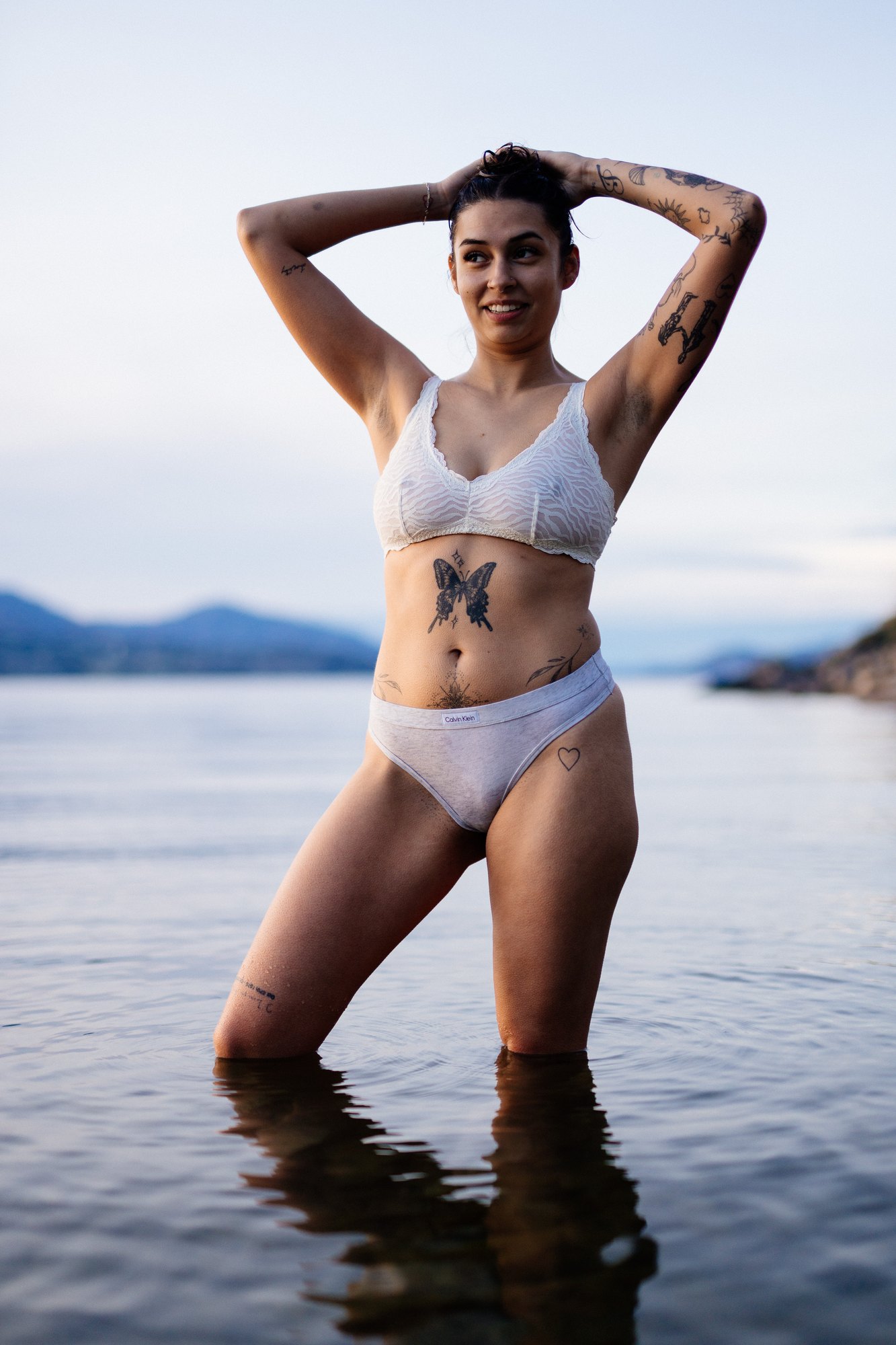 Karly — playful portrait with both hands above her head