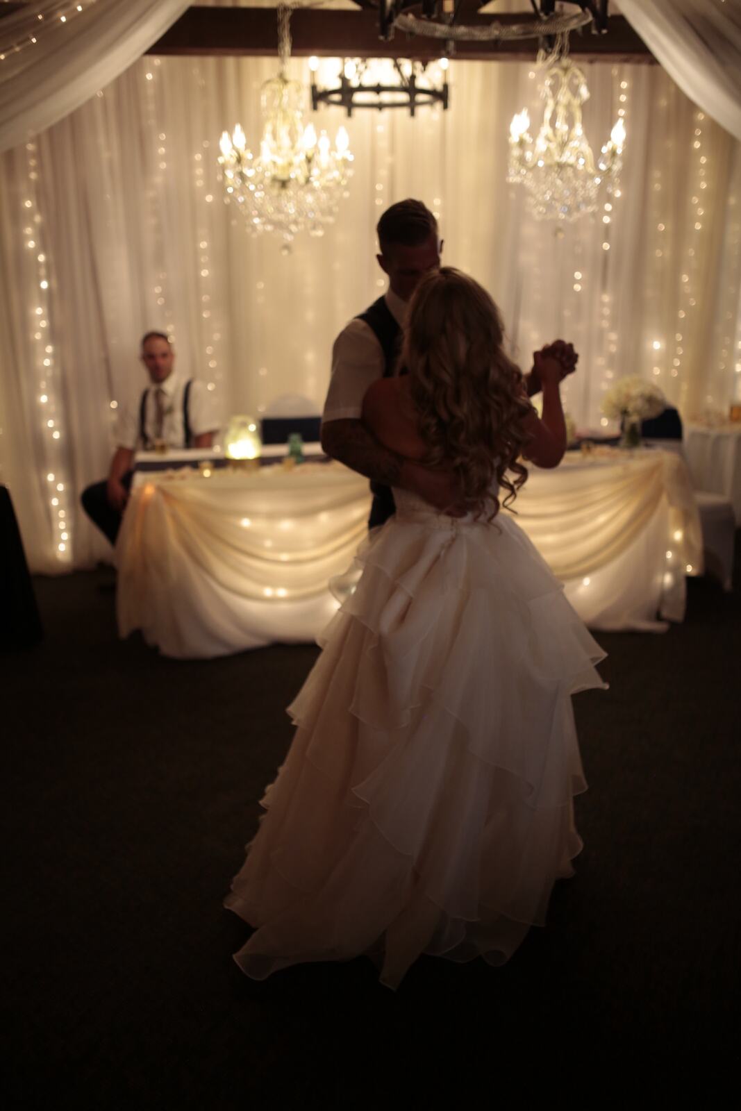 Kendra and Mike story frame 7: An older wedding story with lake dusk, warm room light, speeches, dancing and a full-day feeling.