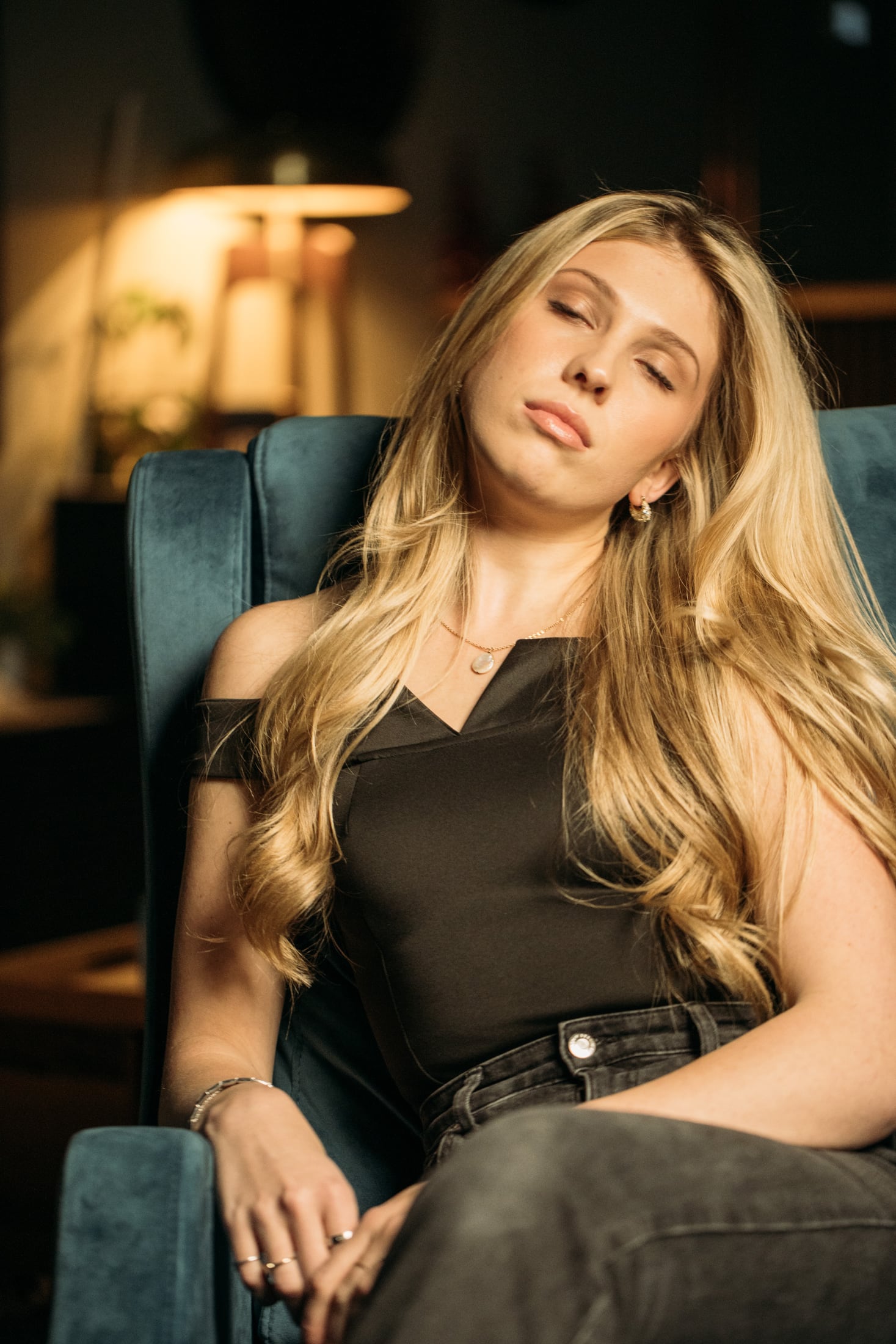 Kennedy seated in a black top with her head tilted