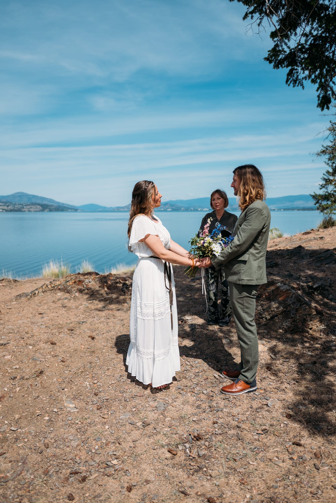 Kristina and Mark weddings story frame 10: A Bertram Creek wedding in South Kelowna with Okanagan Lake light, film-friend history, family texture and Lithuanian food and planning details..