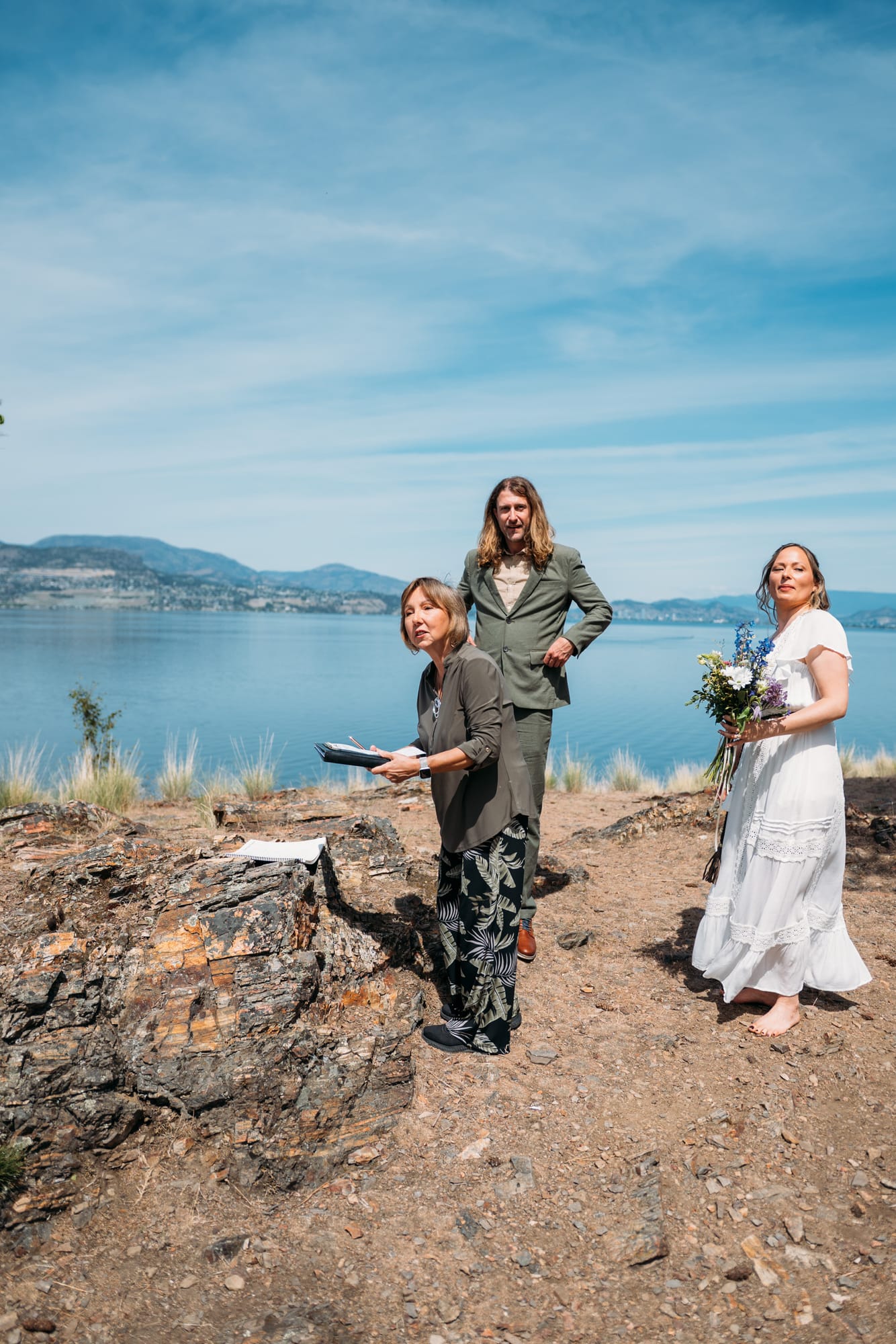 Kristina and Mark weddings story frame 11: A Bertram Creek wedding in South Kelowna with Okanagan Lake light, film-friend history, family texture and Lithuanian food and planning details..