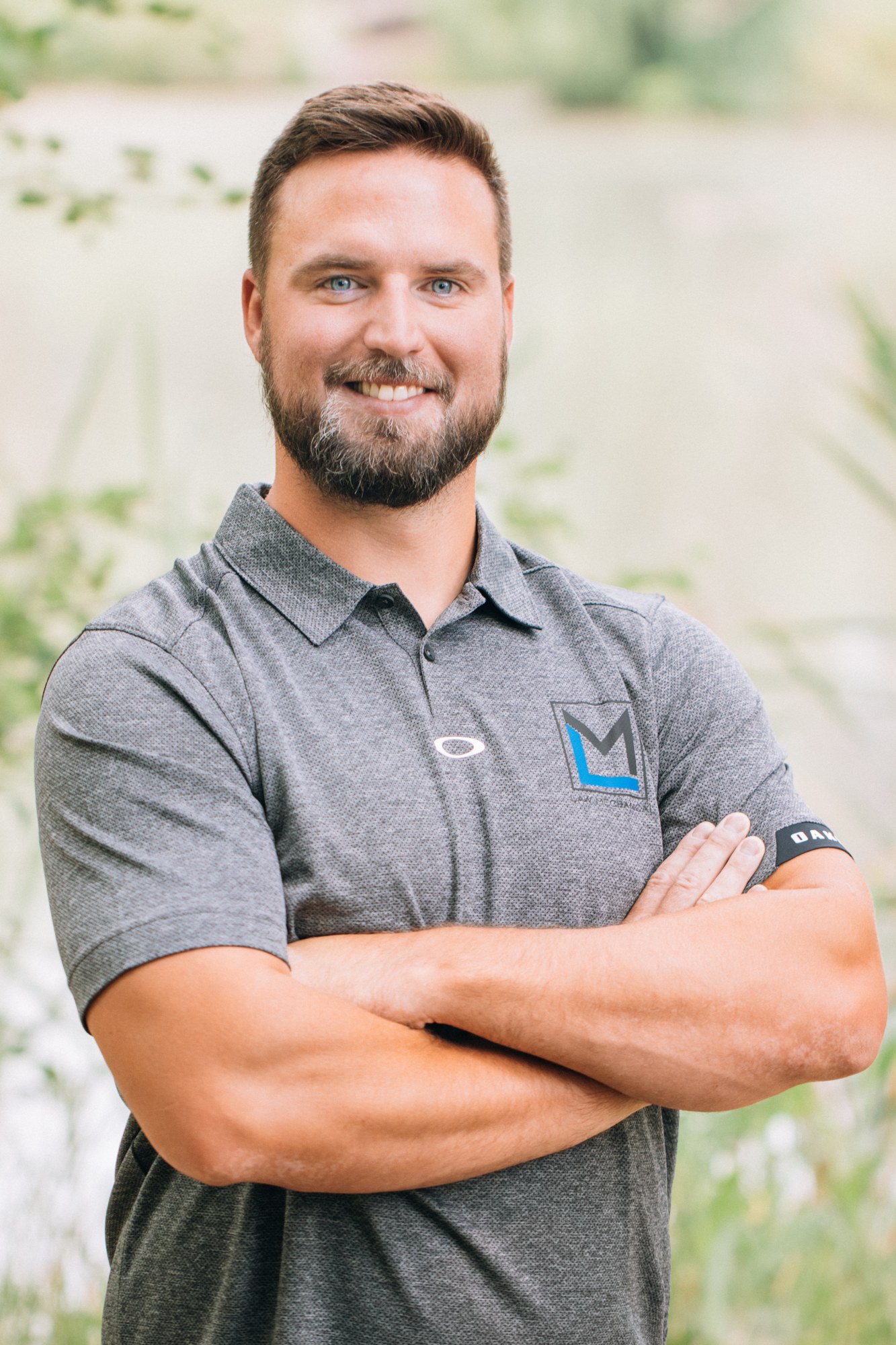 Law Mechanical: Crossed-arm portrait in the Law Mechanical company polo.