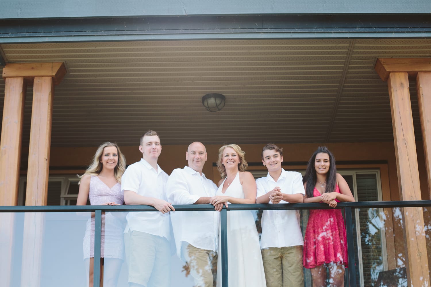 Leeanne and Kelly weddings story frame 3: A Watermark Beach Resort wedding in Osoyoos, built around lakefront context, grown-family connection and careful, big-hearted coverage..