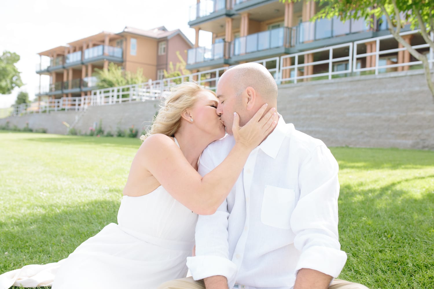 Leeanne and Kelly weddings story frame 6: A Watermark Beach Resort wedding in Osoyoos, built around lakefront context, grown-family connection and careful, big-hearted coverage..