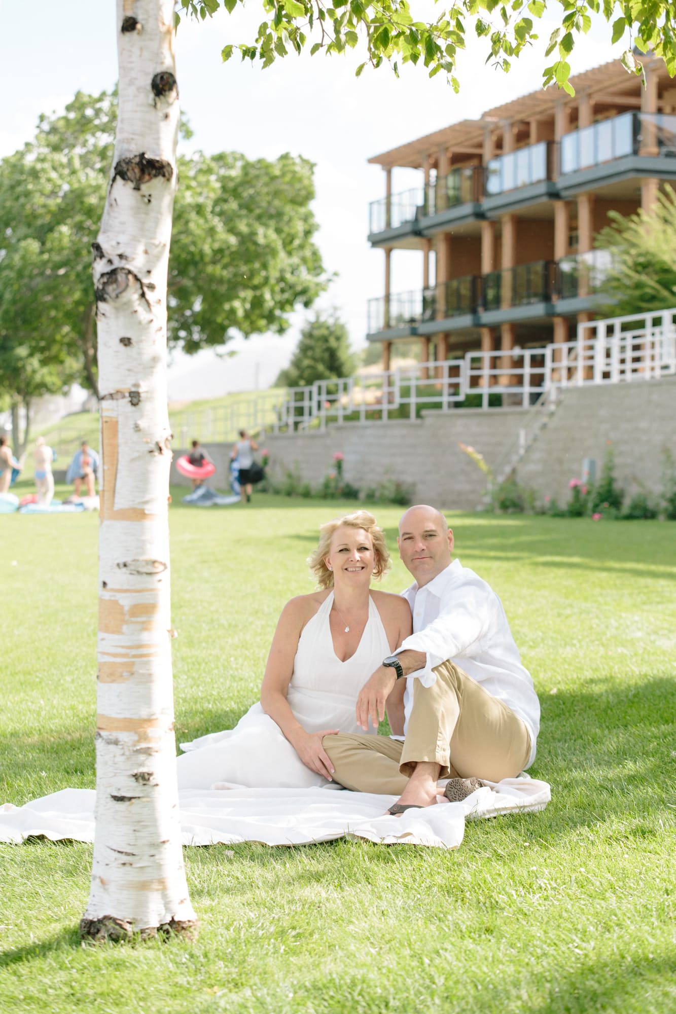Leeanne and Kelly weddings story frame 7: A Watermark Beach Resort wedding in Osoyoos, built around lakefront context, grown-family connection and careful, big-hearted coverage..