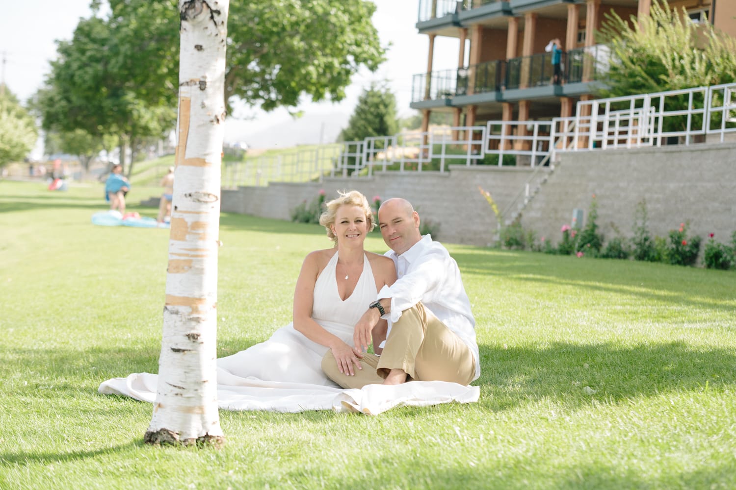 Leeanne and Kelly weddings story frame 8: A Watermark Beach Resort wedding in Osoyoos, built around lakefront context, grown-family connection and careful, big-hearted coverage..