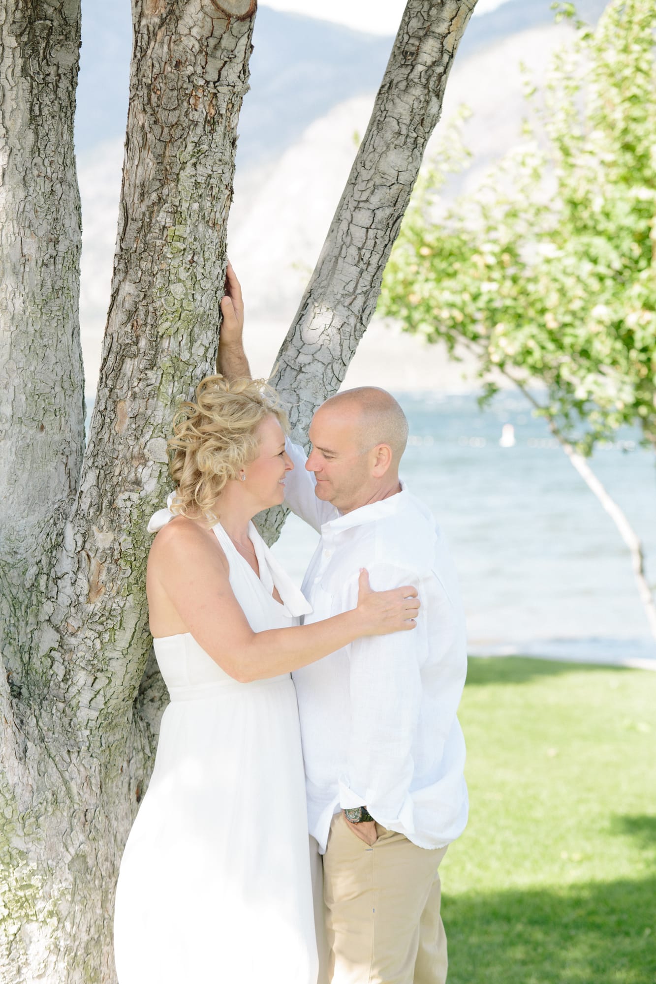 Leeanne and Kelly weddings story frame 10: A Watermark Beach Resort wedding in Osoyoos, built around lakefront context, grown-family connection and careful, big-hearted coverage..