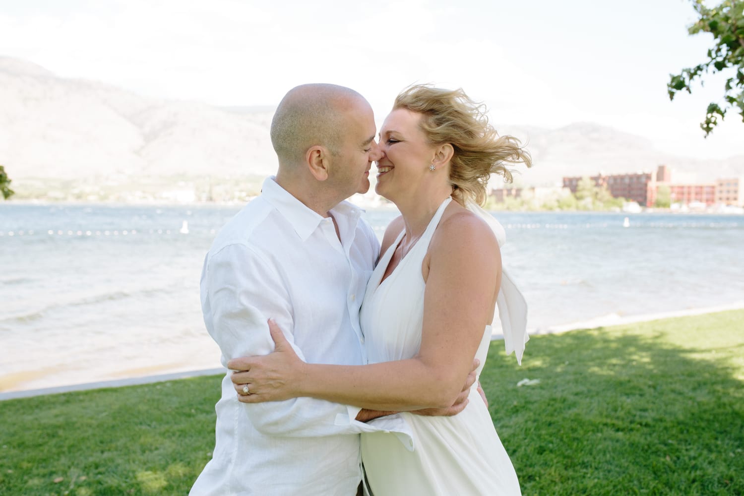 Leeanne and Kelly weddings story frame 12: A Watermark Beach Resort wedding in Osoyoos, built around lakefront context, grown-family connection and careful, big-hearted coverage..