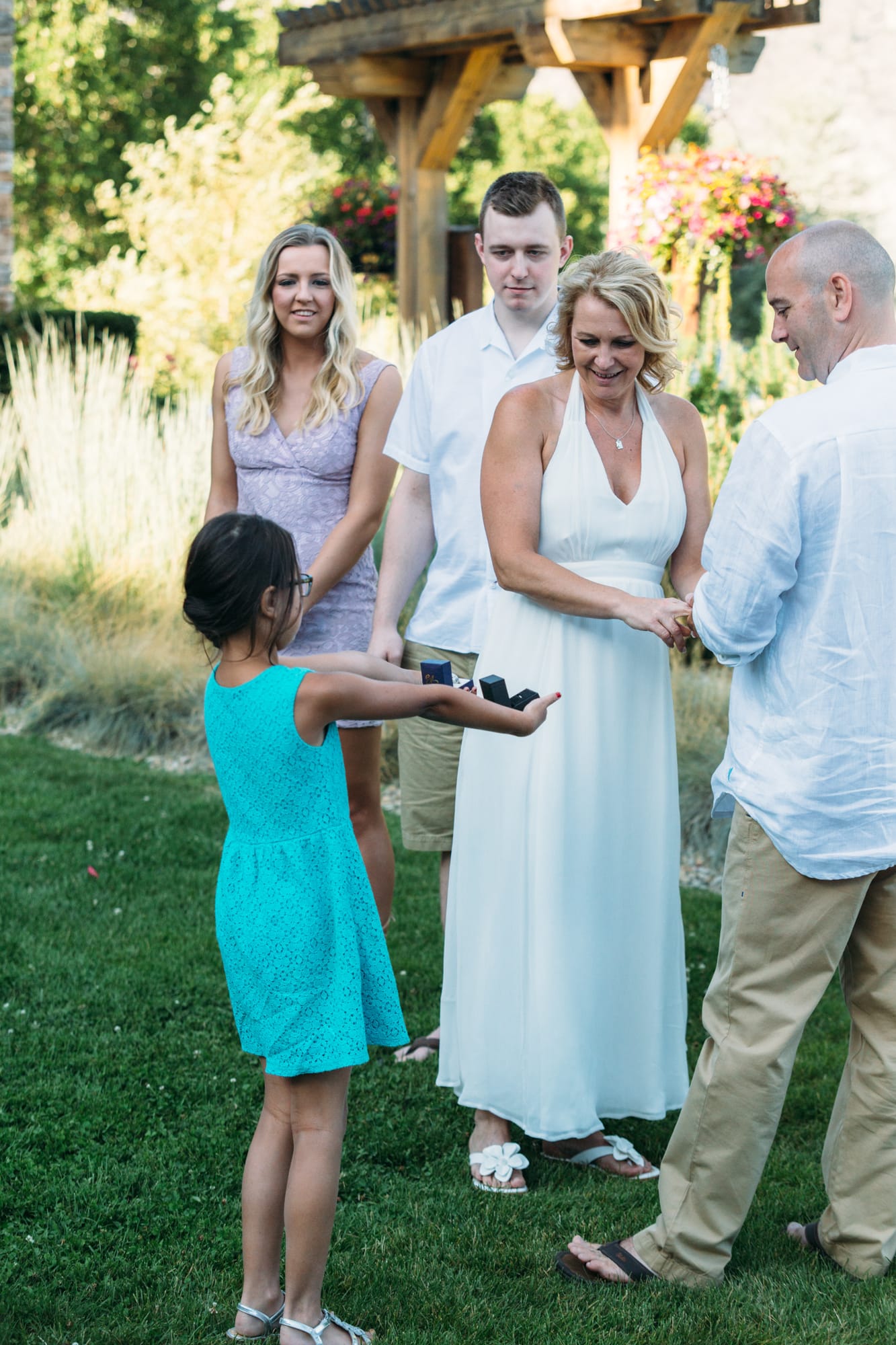 Leeanne and Kelly weddings story frame 21: A Watermark Beach Resort wedding in Osoyoos, built around lakefront context, grown-family connection and careful, big-hearted coverage..