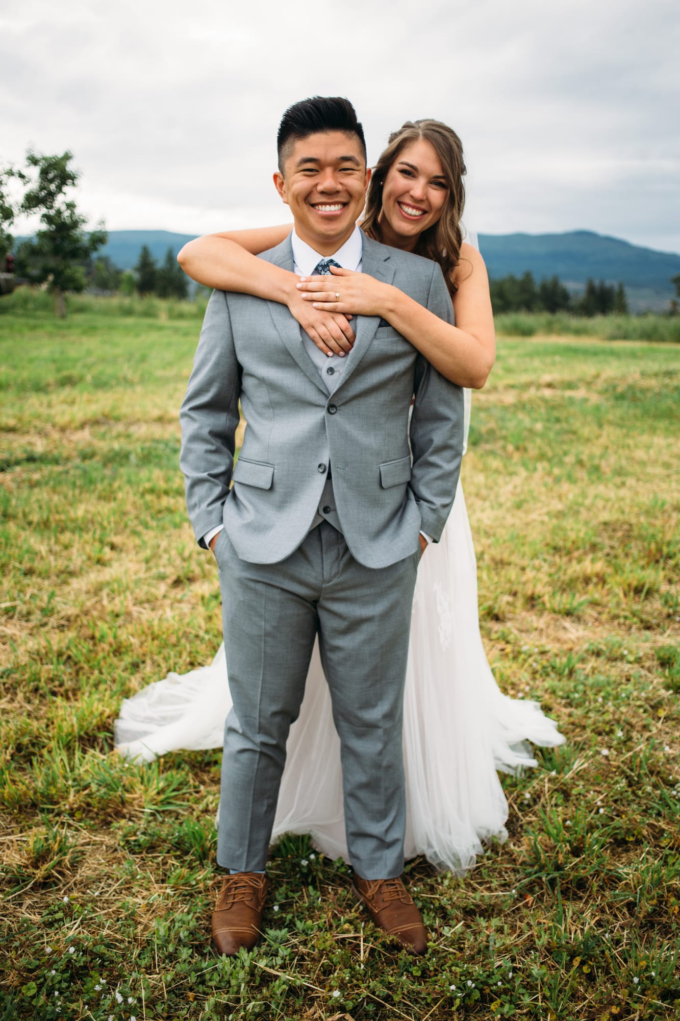 Leslie and Gerome weddings story frame 5: A Brook & Barn - Casorso Heritage Farm wedding in Kelowna, with orchard details, outbuildings, lawn games and a familiar friend-party feeling..