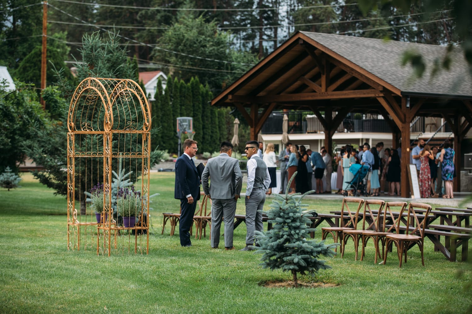 Leslie and Gerome weddings story frame 10: A Brook & Barn - Casorso Heritage Farm wedding in Kelowna, with orchard details, outbuildings, lawn games and a familiar friend-party feeling..