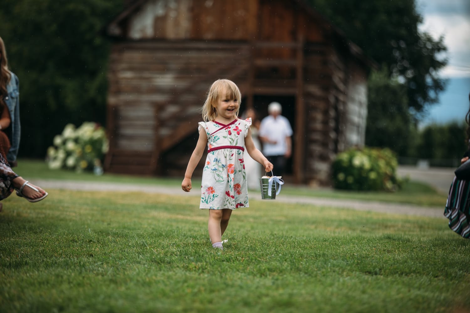 Leslie and Gerome weddings story frame 15: A Brook & Barn - Casorso Heritage Farm wedding in Kelowna, with orchard details, outbuildings, lawn games and a familiar friend-party feeling..