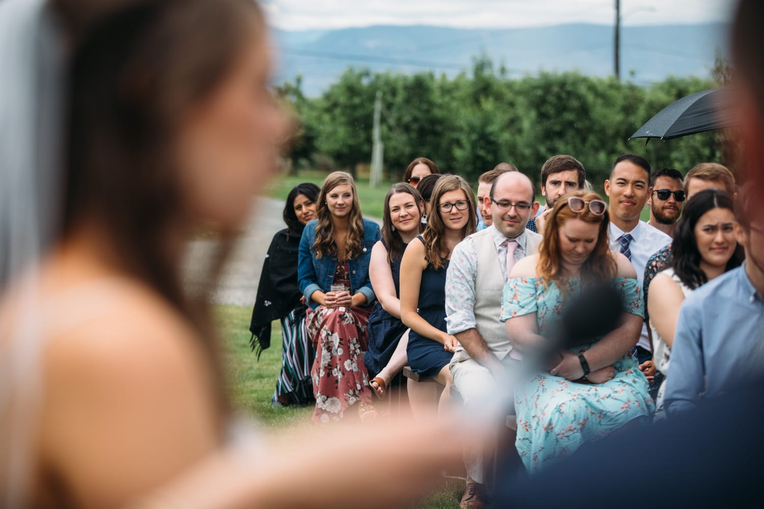 Leslie and Gerome weddings story frame 17: A Brook & Barn - Casorso Heritage Farm wedding in Kelowna, with orchard details, outbuildings, lawn games and a familiar friend-party feeling..