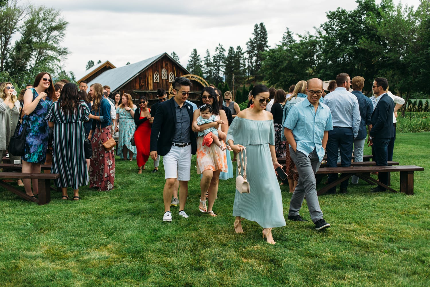 Leslie and Gerome weddings story frame 20: A Brook & Barn - Casorso Heritage Farm wedding in Kelowna, with orchard details, outbuildings, lawn games and a familiar friend-party feeling..