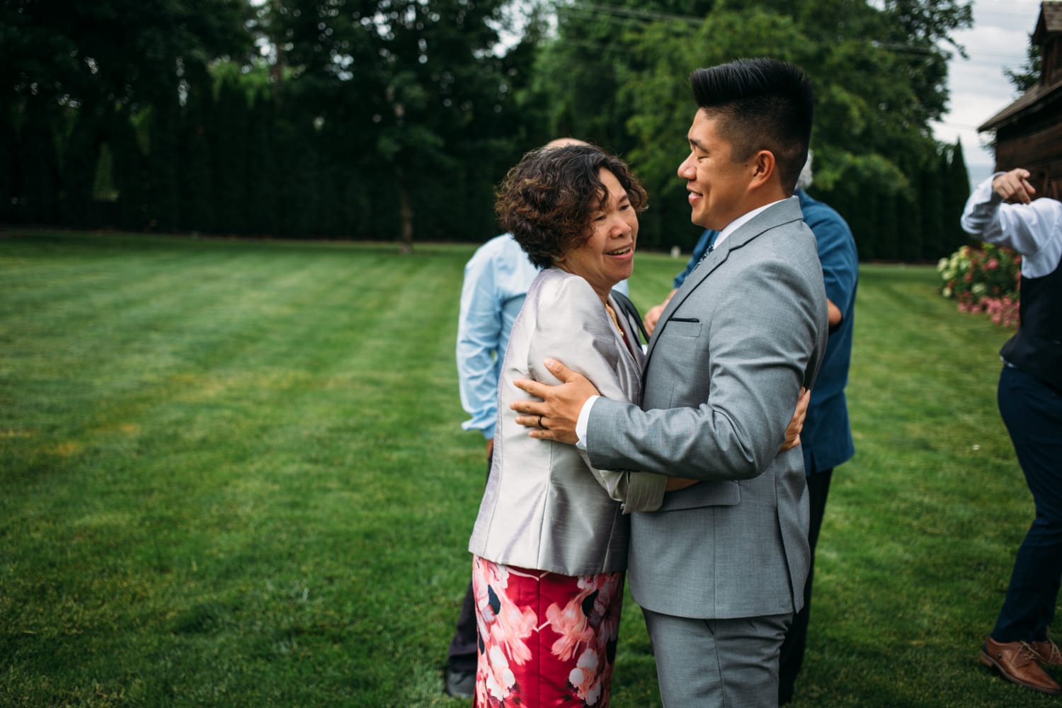 Leslie and Gerome weddings story frame 21: A Brook & Barn - Casorso Heritage Farm wedding in Kelowna, with orchard details, outbuildings, lawn games and a familiar friend-party feeling..