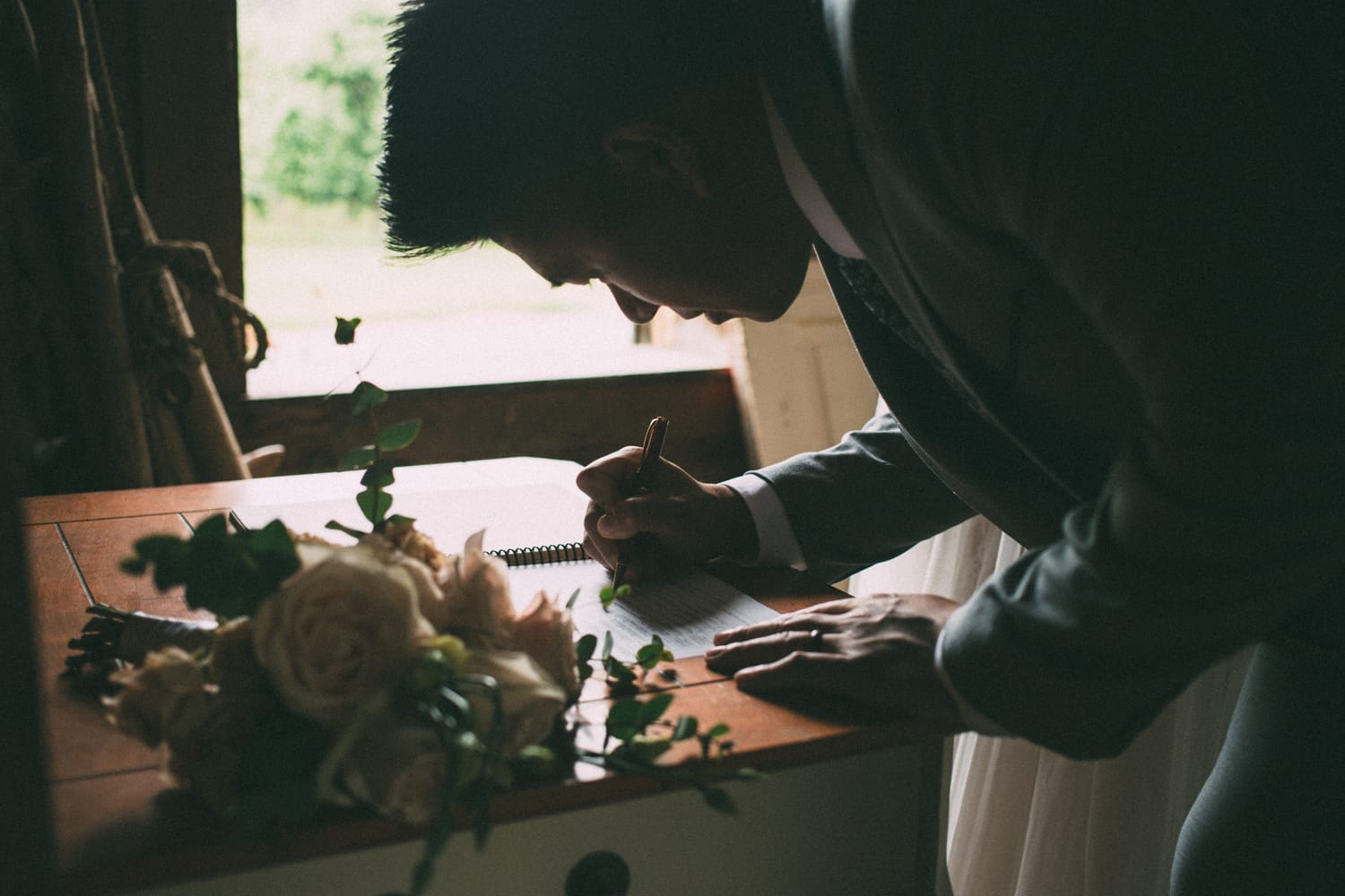 Leslie and Gerome weddings story frame 22: A Brook & Barn - Casorso Heritage Farm wedding in Kelowna, with orchard details, outbuildings, lawn games and a familiar friend-party feeling..