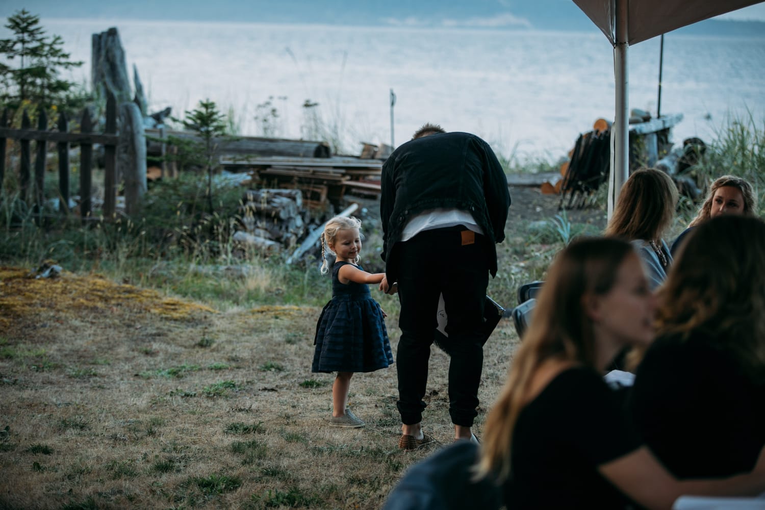 Mara and Casey weddings story frame 7: A Vancouver Island private-home wedding near Qualicum Beach, with Bowser prep, Friday gathering energy, custom vendors, kids, friends and cool Island air..
