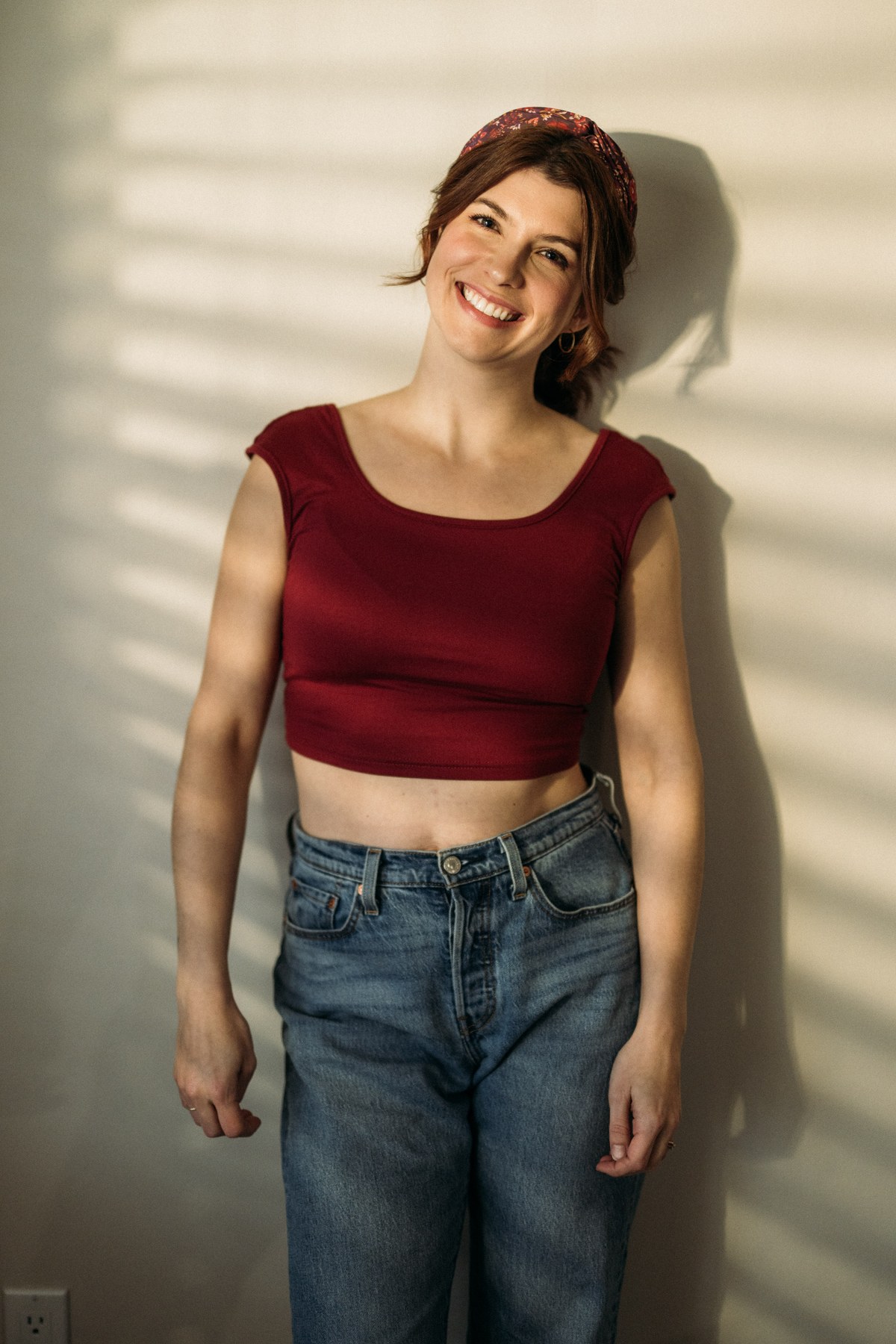 Marie at Clement portraits story frame 6: Actor and performer portraits on Clement Avenue in Kelowna, with red, black and leather wardrobe changes, slatted light and portfolio range for casting, promo and look-book use.