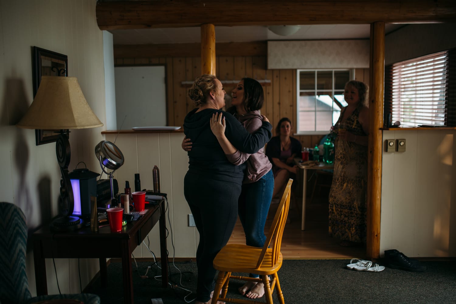 Marie and Mark weddings story frame 9: A Mabel Lake Airpark wedding in the North Okanagan, with grass-runway scenery, open-air photos and sweet family help around makeup, flowers and petals..