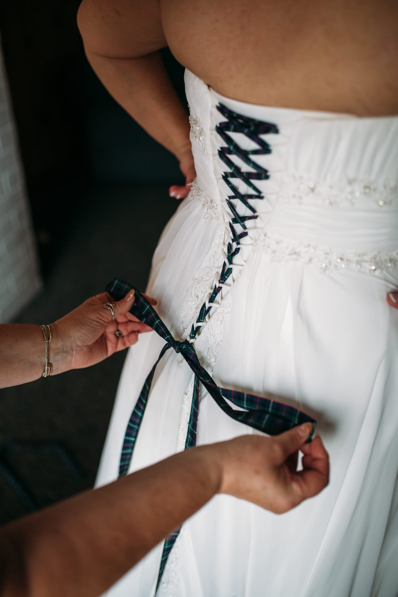 Marie and Mark weddings story frame 10: A Mabel Lake Airpark wedding in the North Okanagan, with grass-runway scenery, open-air photos and sweet family help around makeup, flowers and petals..