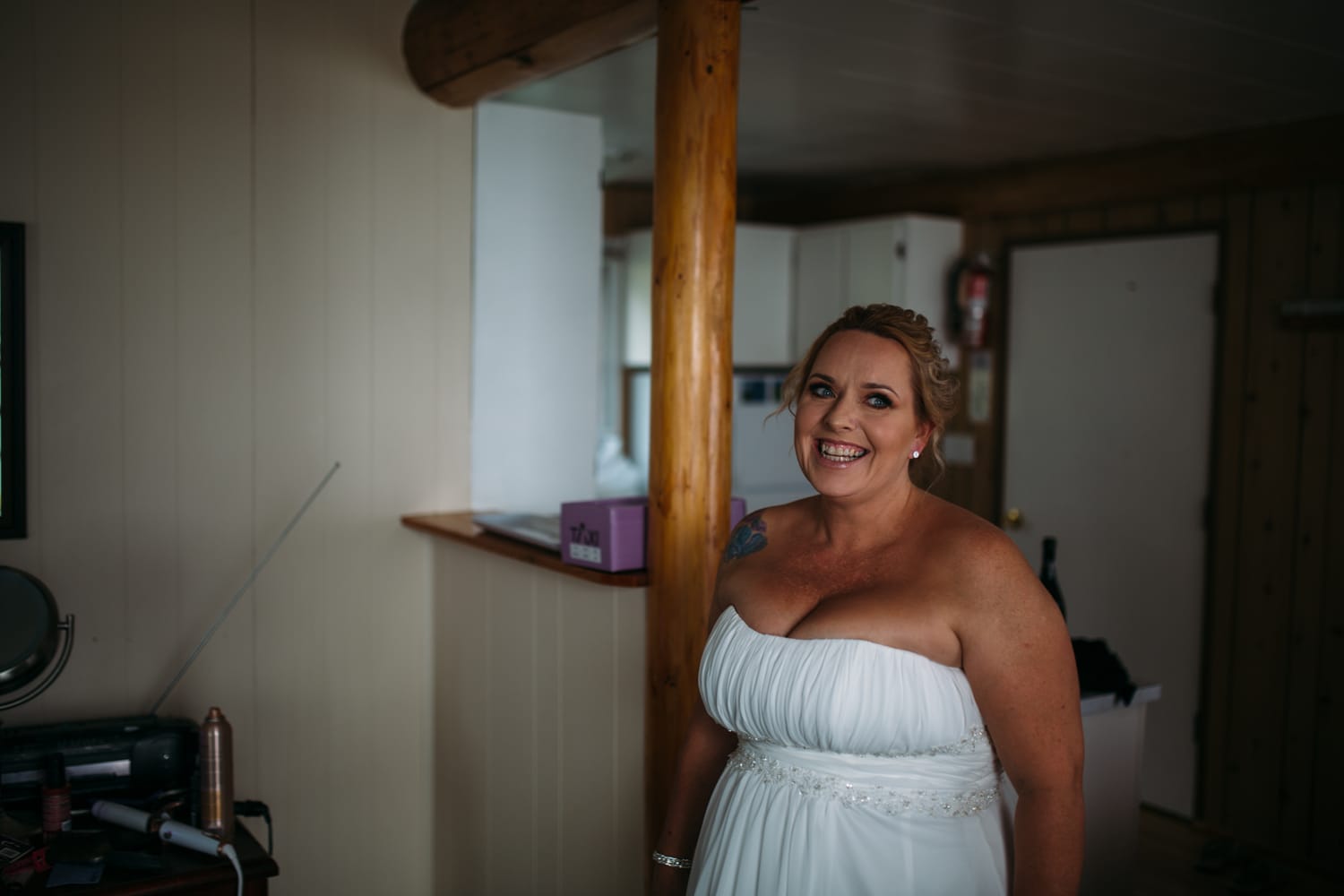 Marie and Mark weddings story frame 11: A Mabel Lake Airpark wedding in the North Okanagan, with grass-runway scenery, open-air photos and sweet family help around makeup, flowers and petals..