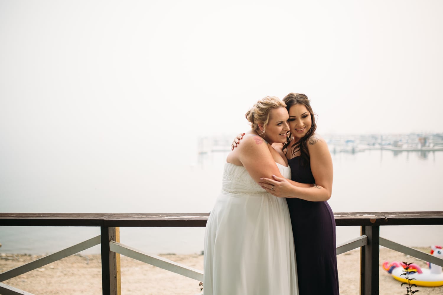 Marie and Mark weddings story frame 13: A Mabel Lake Airpark wedding in the North Okanagan, with grass-runway scenery, open-air photos and sweet family help around makeup, flowers and petals..