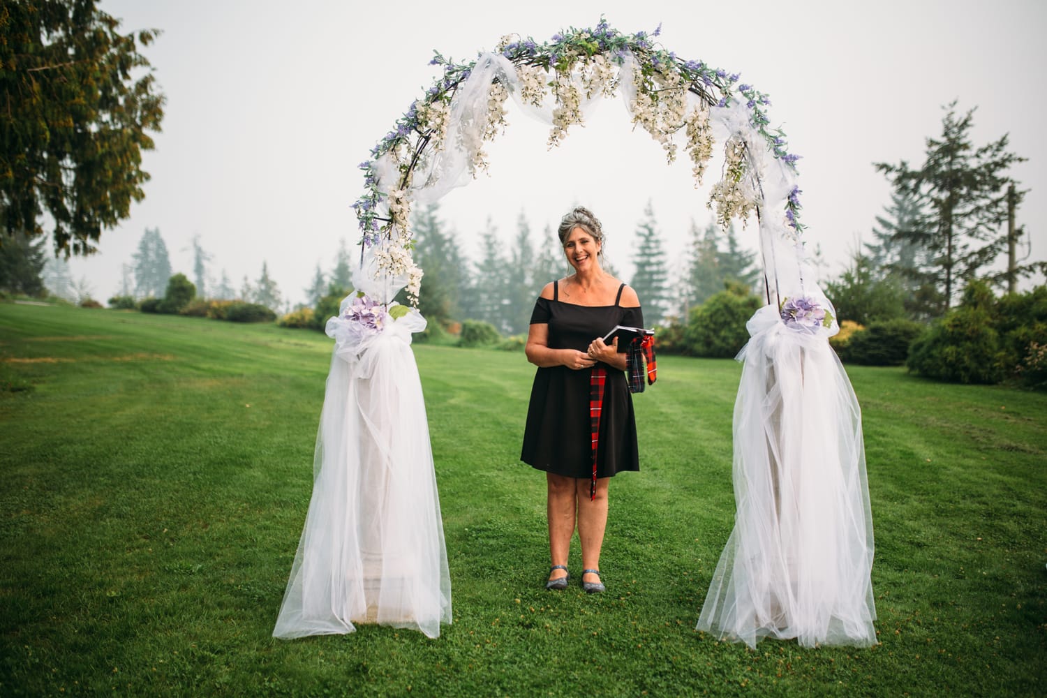 Marie and Mark weddings story frame 15: A Mabel Lake Airpark wedding in the North Okanagan, with grass-runway scenery, open-air photos and sweet family help around makeup, flowers and petals..