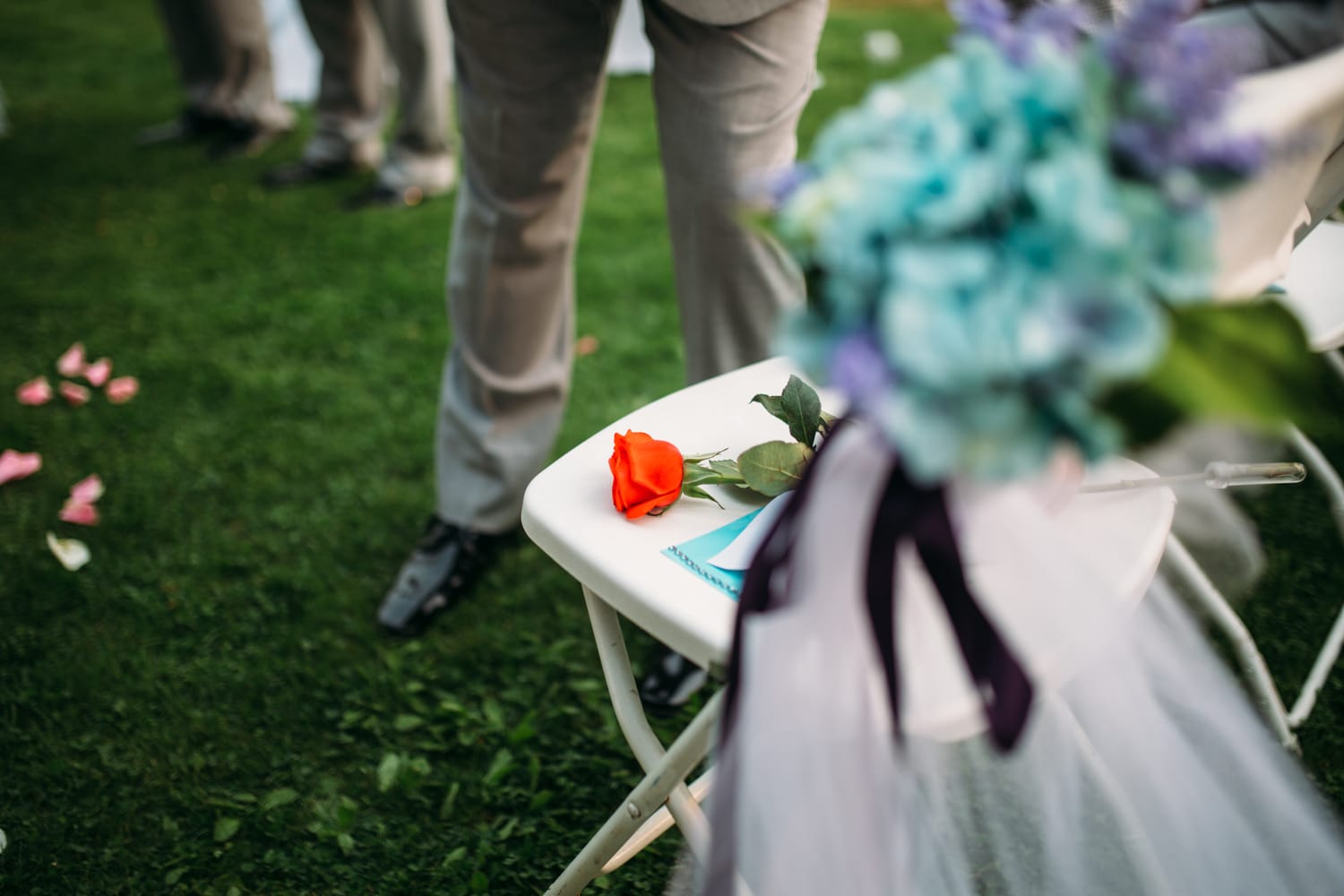 Marie and Mark weddings story frame 19: A Mabel Lake Airpark wedding in the North Okanagan, with grass-runway scenery, open-air photos and sweet family help around makeup, flowers and petals..