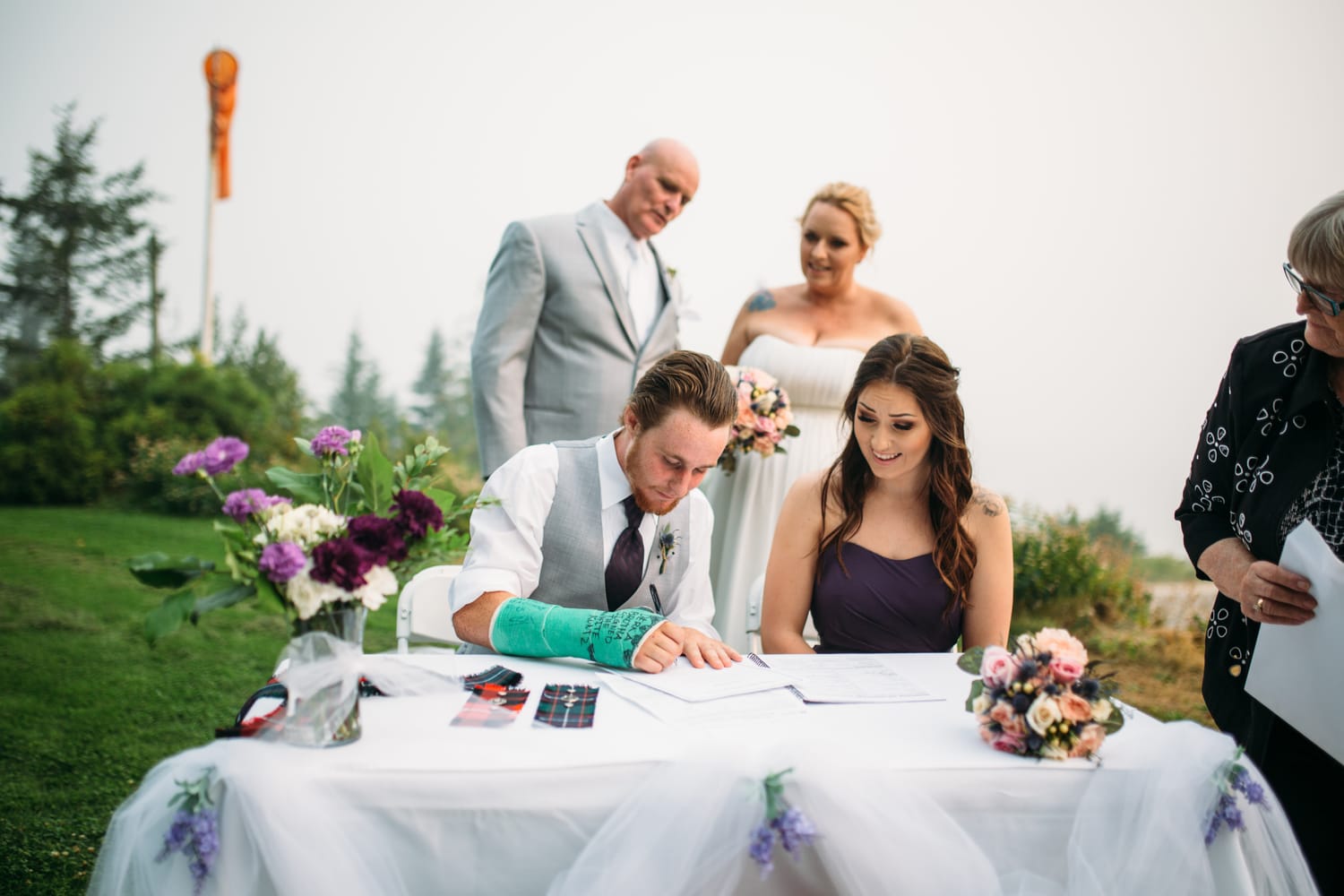 Marie and Mark weddings story frame 23: A Mabel Lake Airpark wedding in the North Okanagan, with grass-runway scenery, open-air photos and sweet family help around makeup, flowers and petals..
